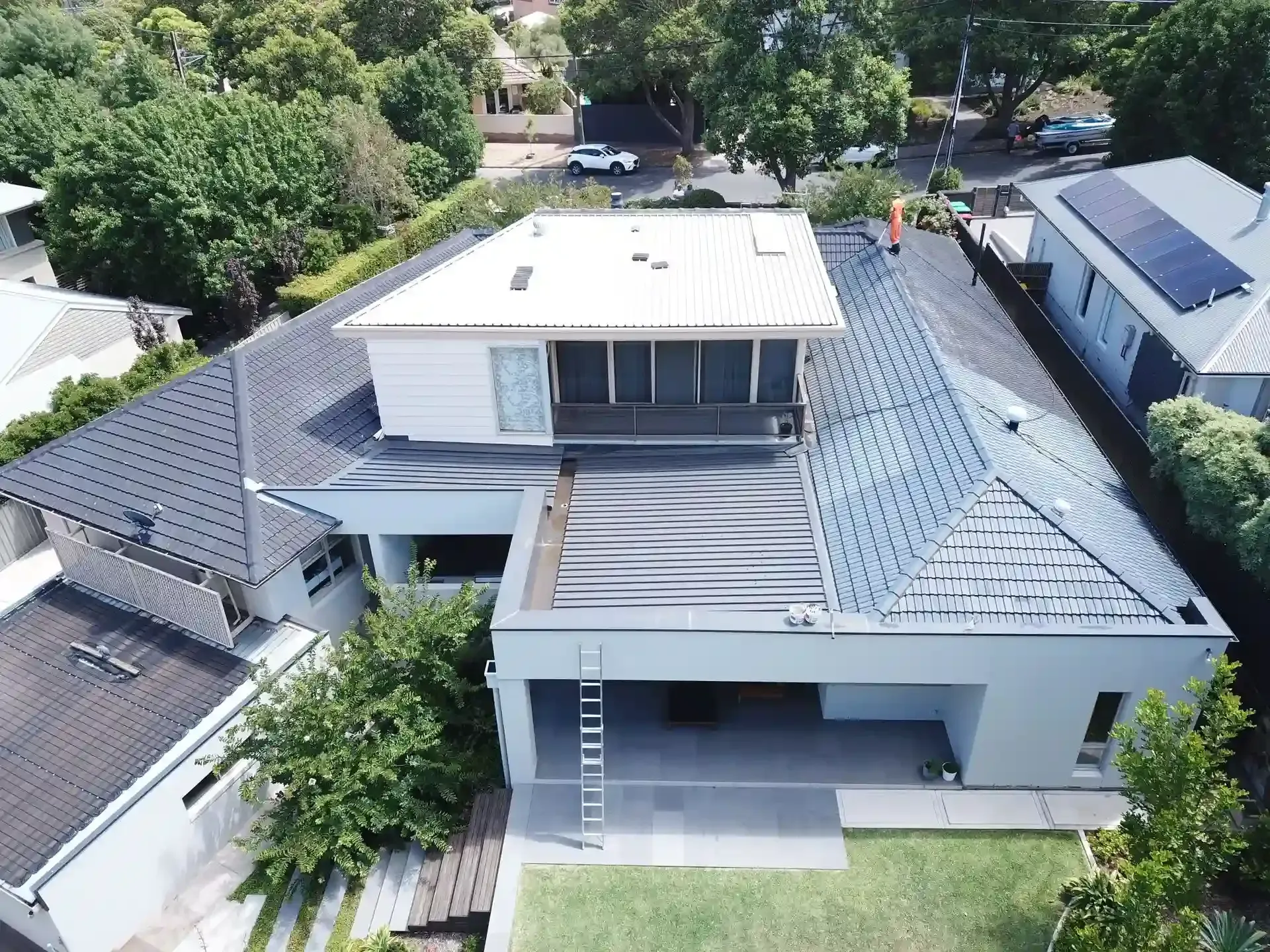 An aerial view of a house with a black roof