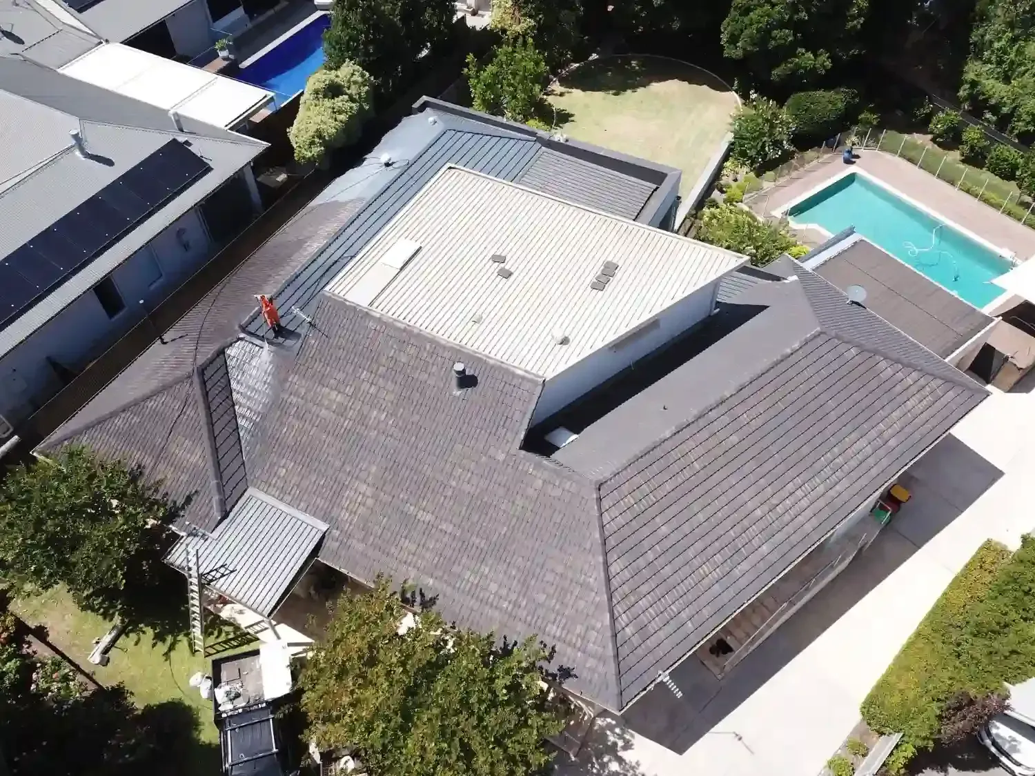 An aerial view of a house with a pool in the backyard
