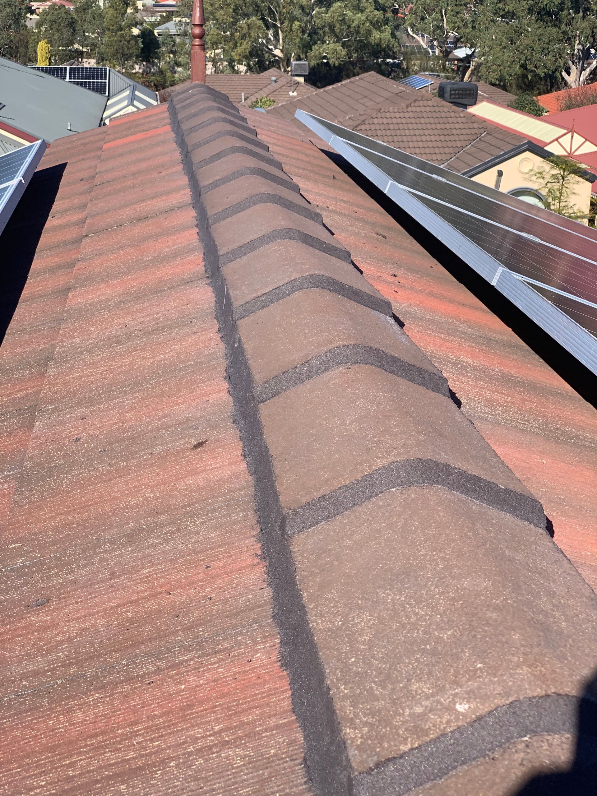 A close up of a roof with solar panels on it.