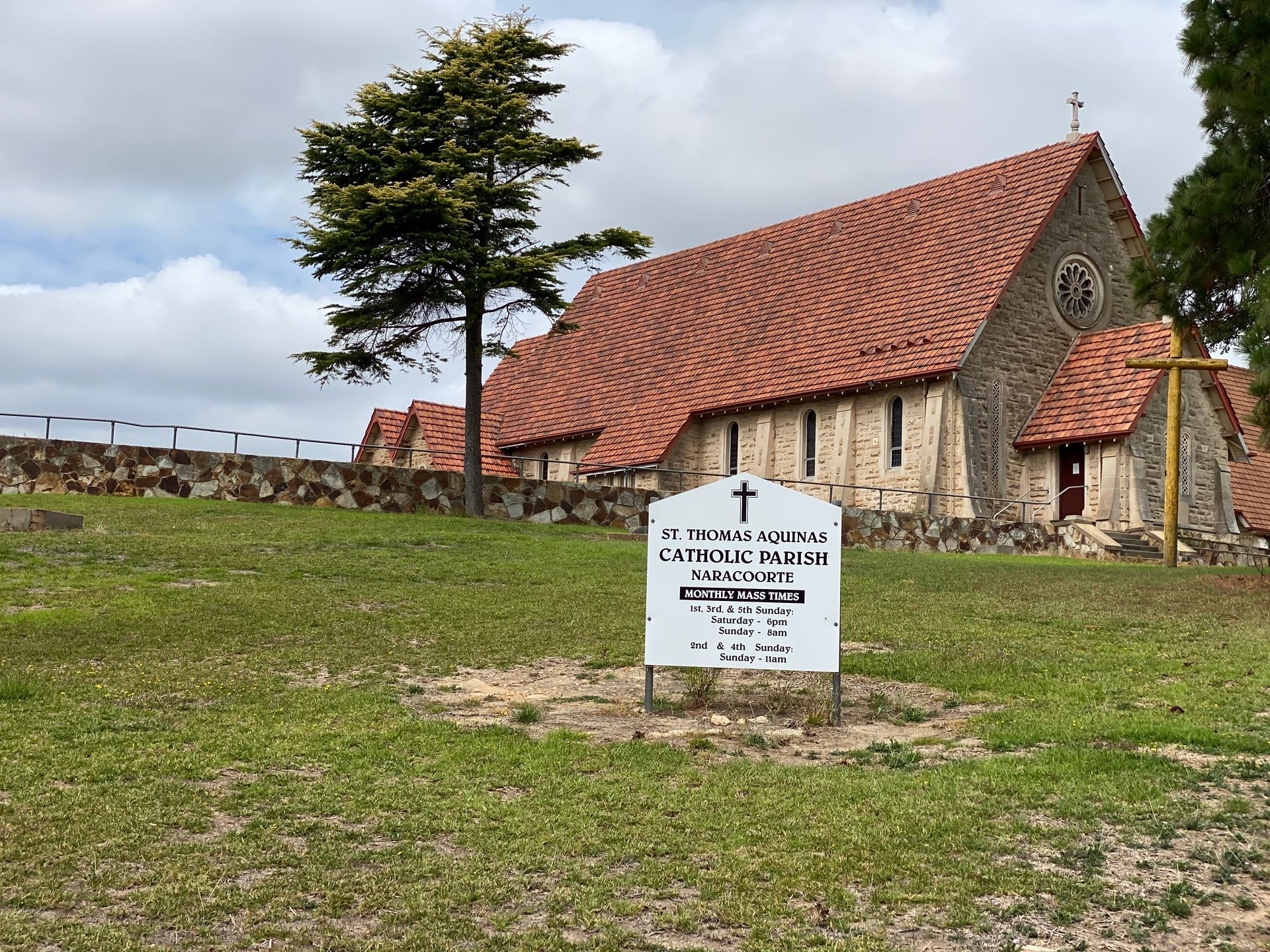 A large church with a sign in front of it