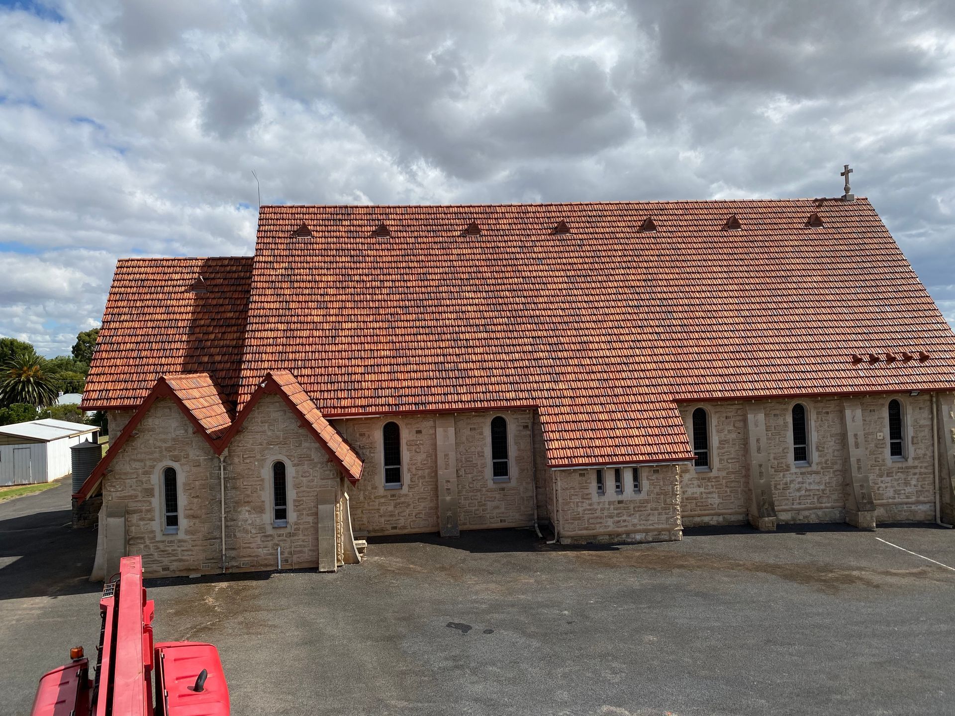 A large brick building with a red tiled roof