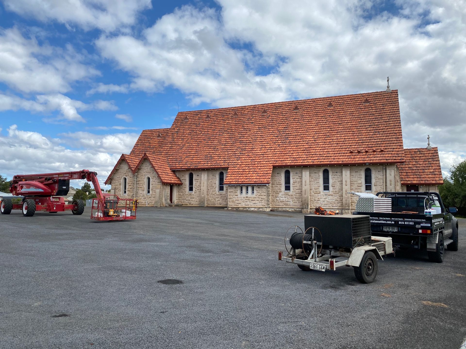 A truck is parked in front of a large building.