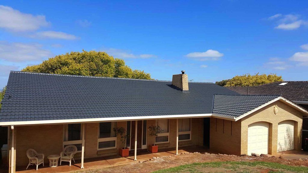 A house with a black roof and a porch