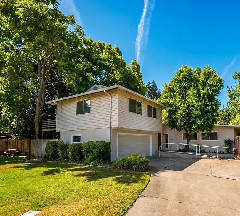 A white house with a garage and a driveway