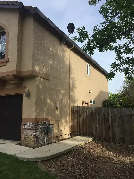 A house with a satellite dish on the side of it