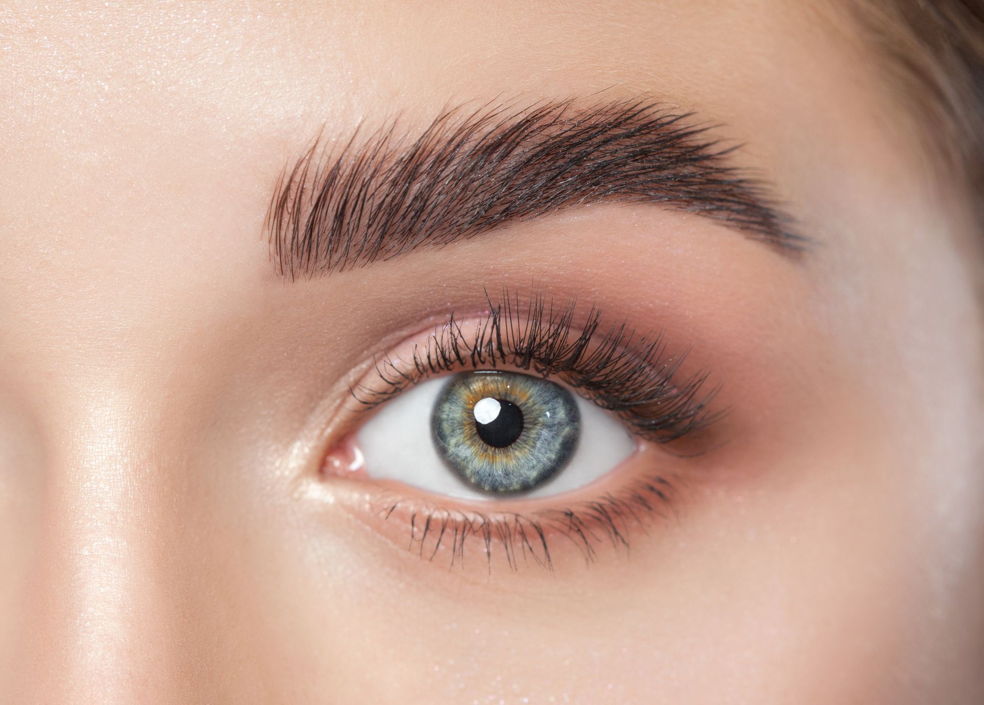 A close up of a woman 's eye with makeup on.