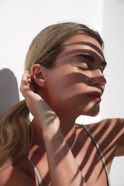 A close up of a woman 's face with her eyes closed.