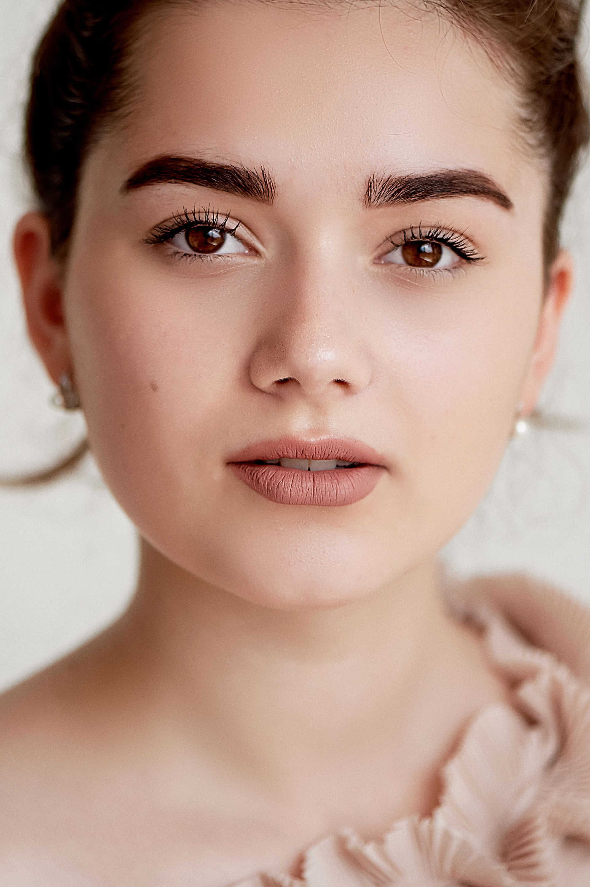 A close up of a woman 's face with makeup on.