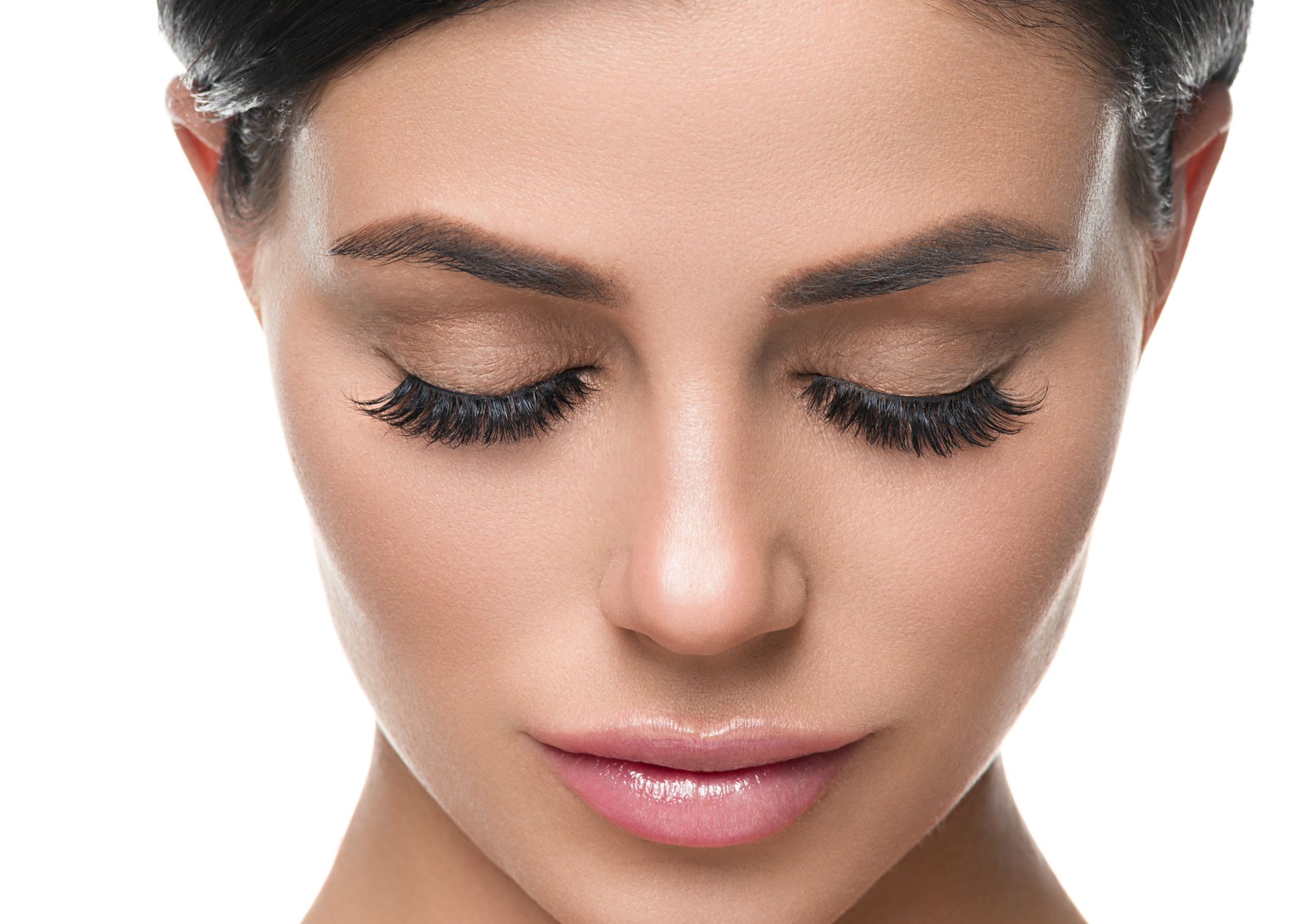 A close up of a woman 's face with her eyes closed