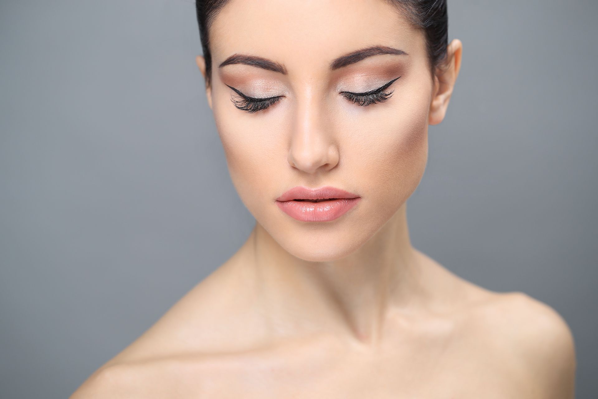 A close up of a woman 's face with her eyes closed.