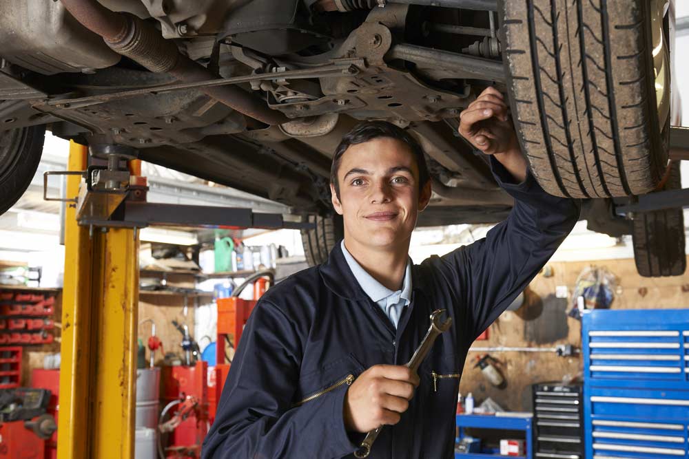 Apprentice Mechanic Working On Car — Mechanic In Marulan, NSW