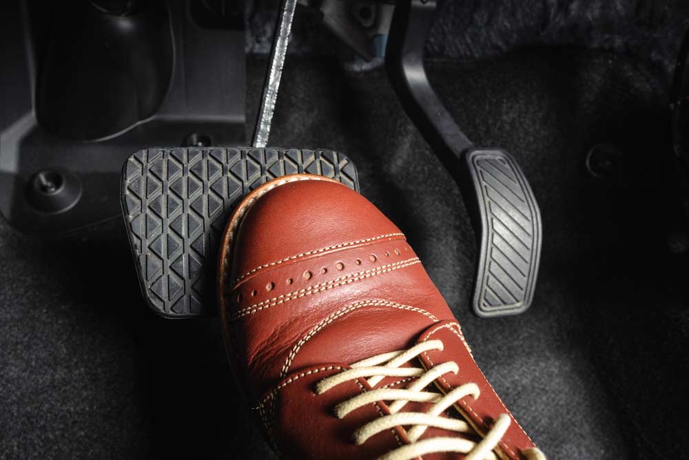 Foot Pressing The Brake Pedal Of A Car — Mechanic In Marulan, NSW