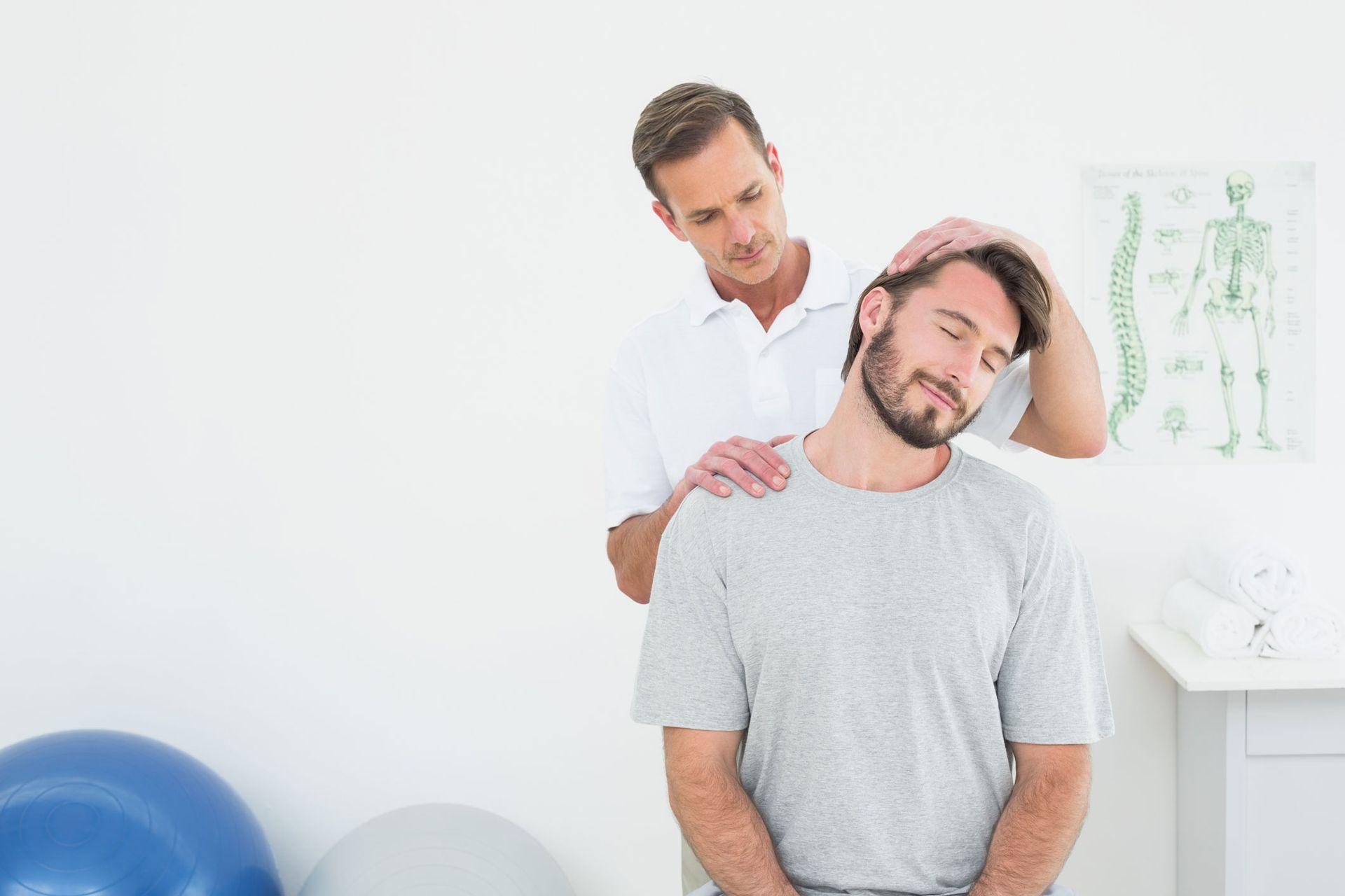 A chiropractor is doing a neck adjustment. A chiropractor is doing a neck adjustment.