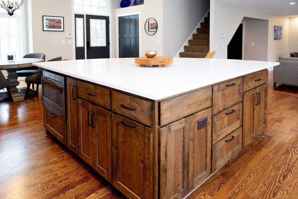 There is a large island in the middle of the kitchen.