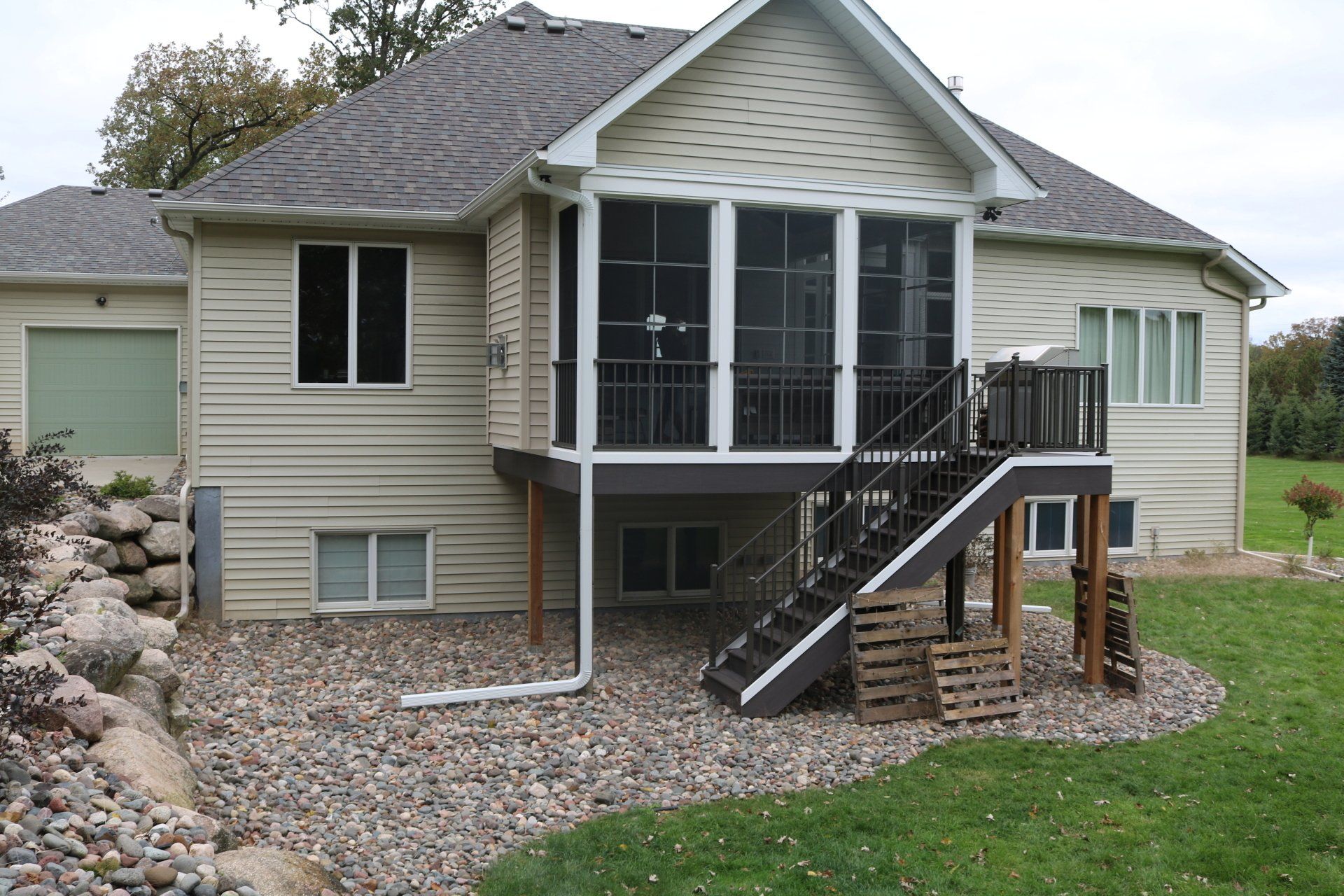 A house with a screened in porch and stairs