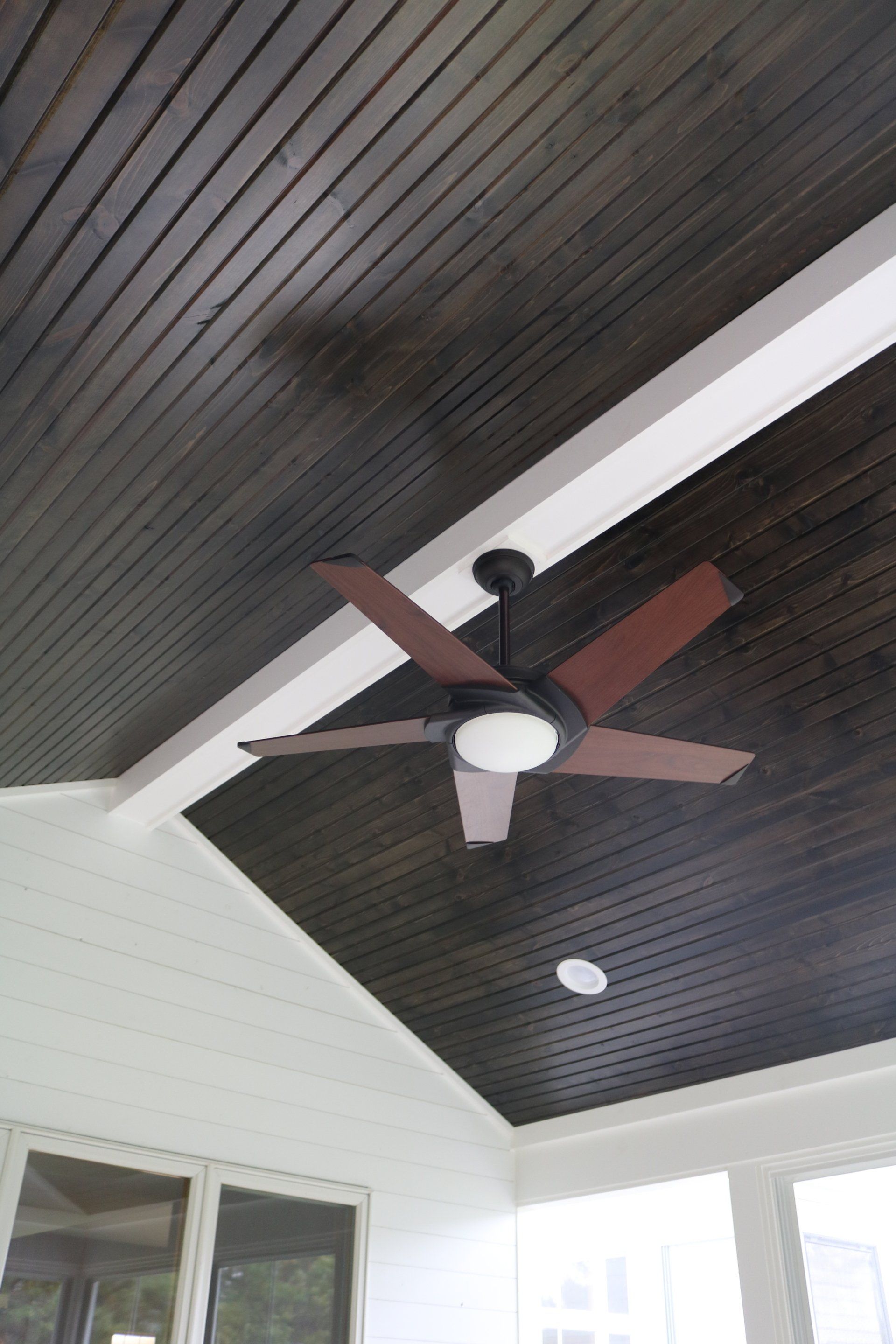 A ceiling fan is hanging from the ceiling of a room.