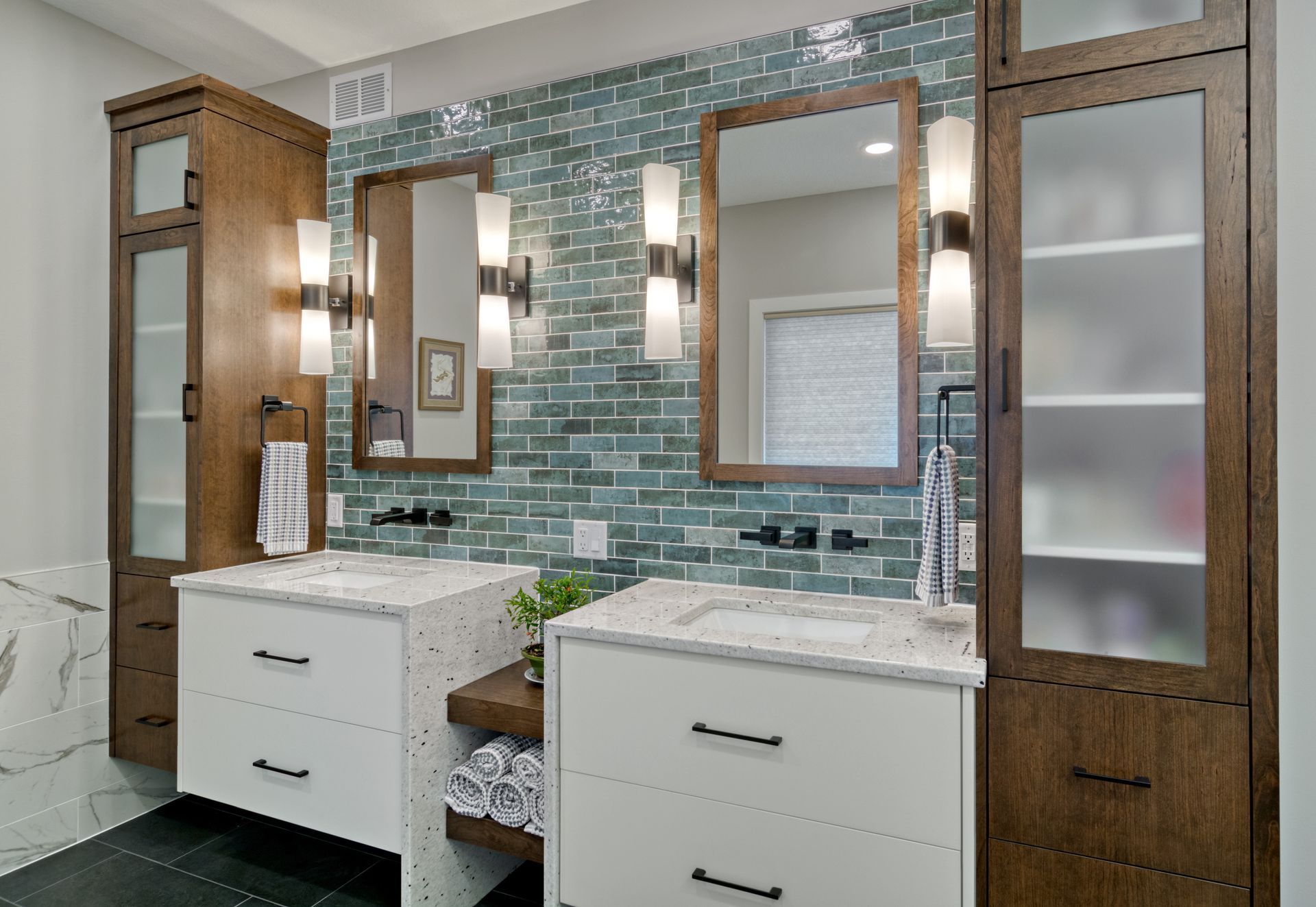 A bathroom with two sinks and two mirrors.