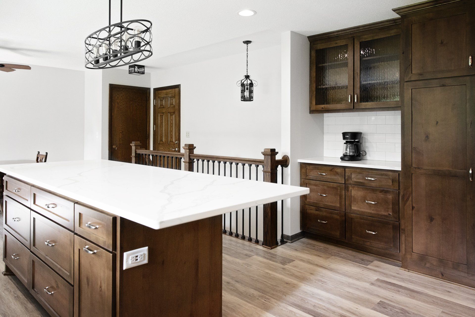 A kitchen with a large island and wooden cabinets.
