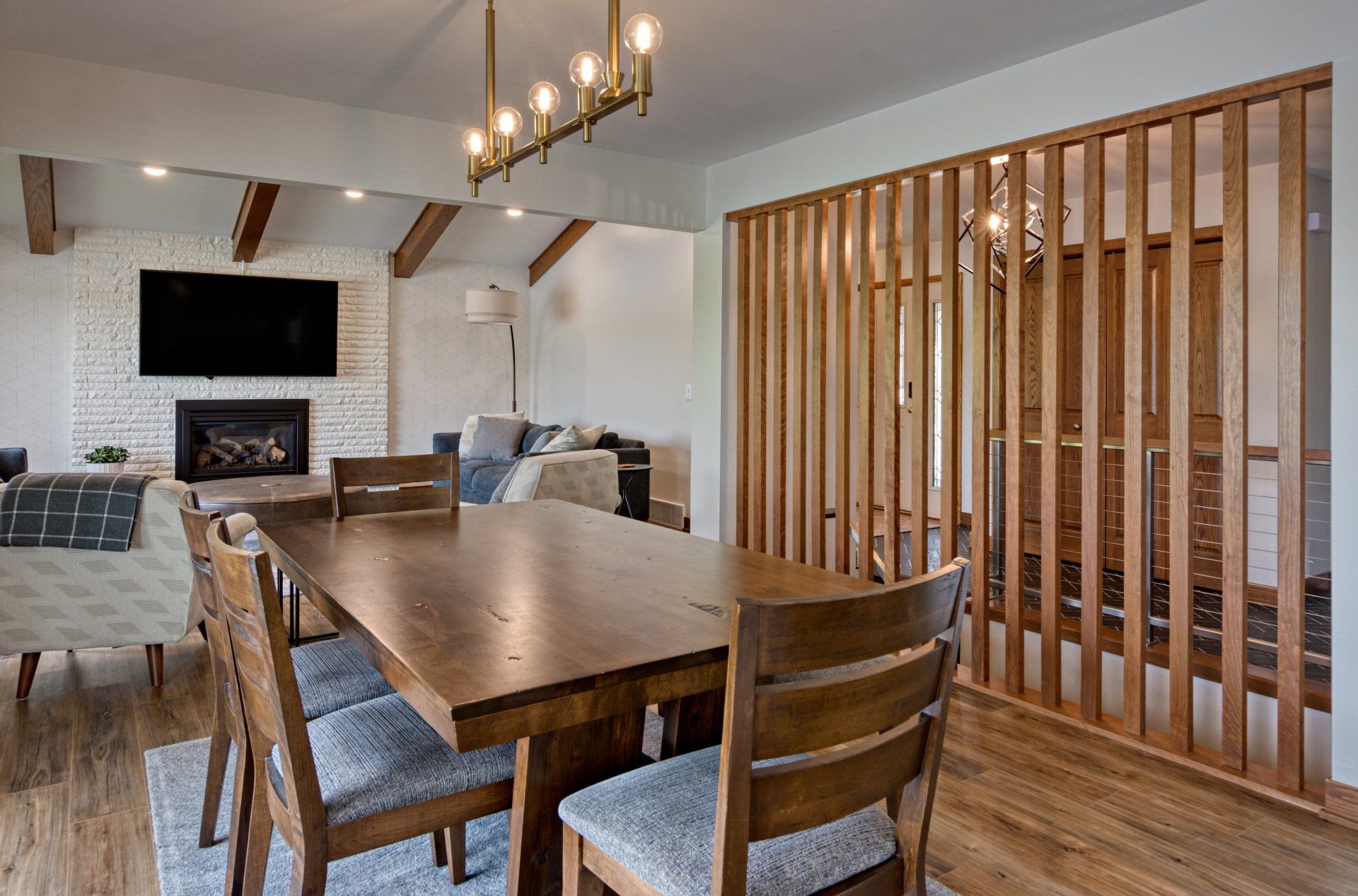 There is a dining table and chairs in the middle of the room.