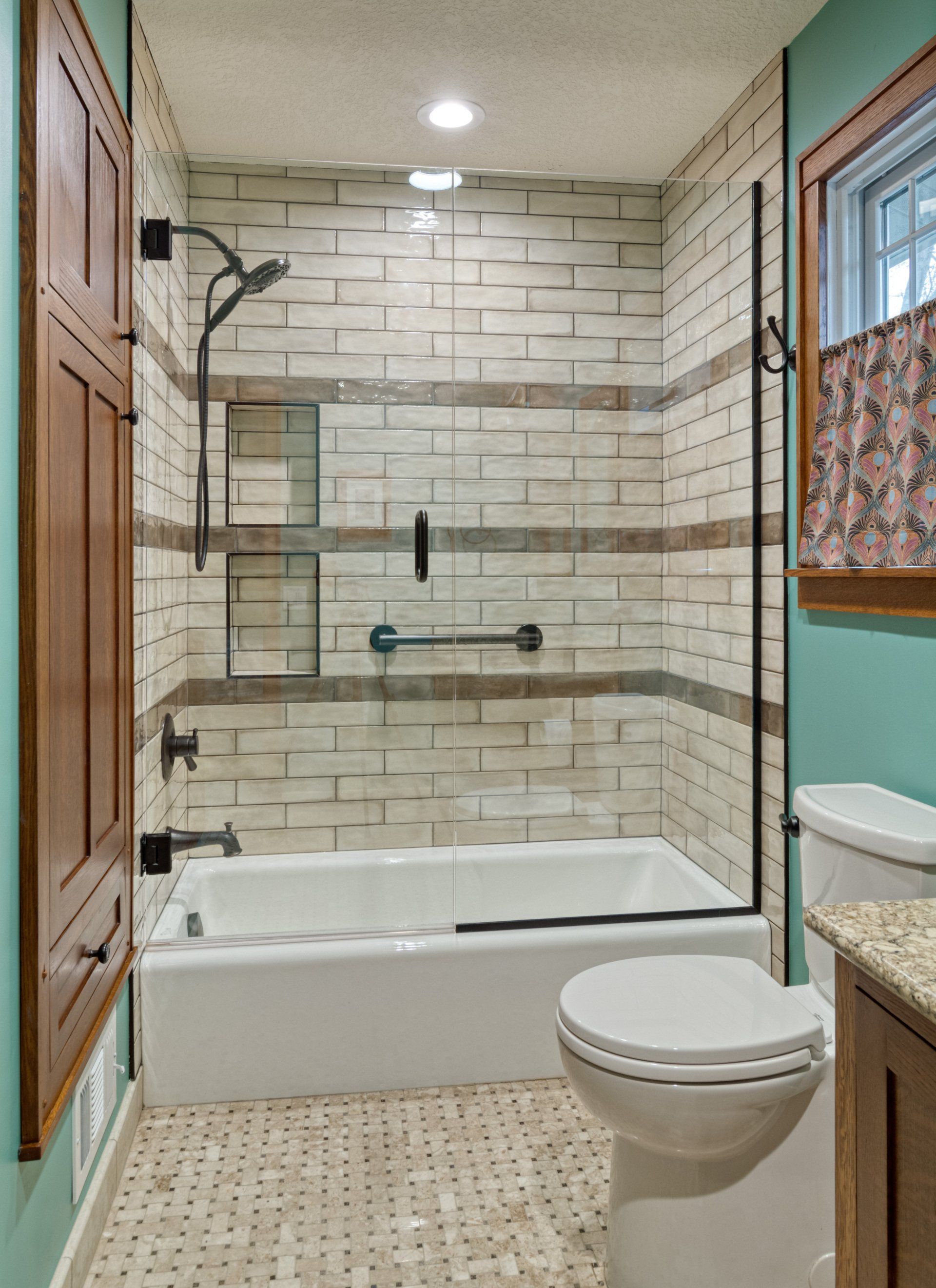 A bathroom with a tub , toilet and shower.