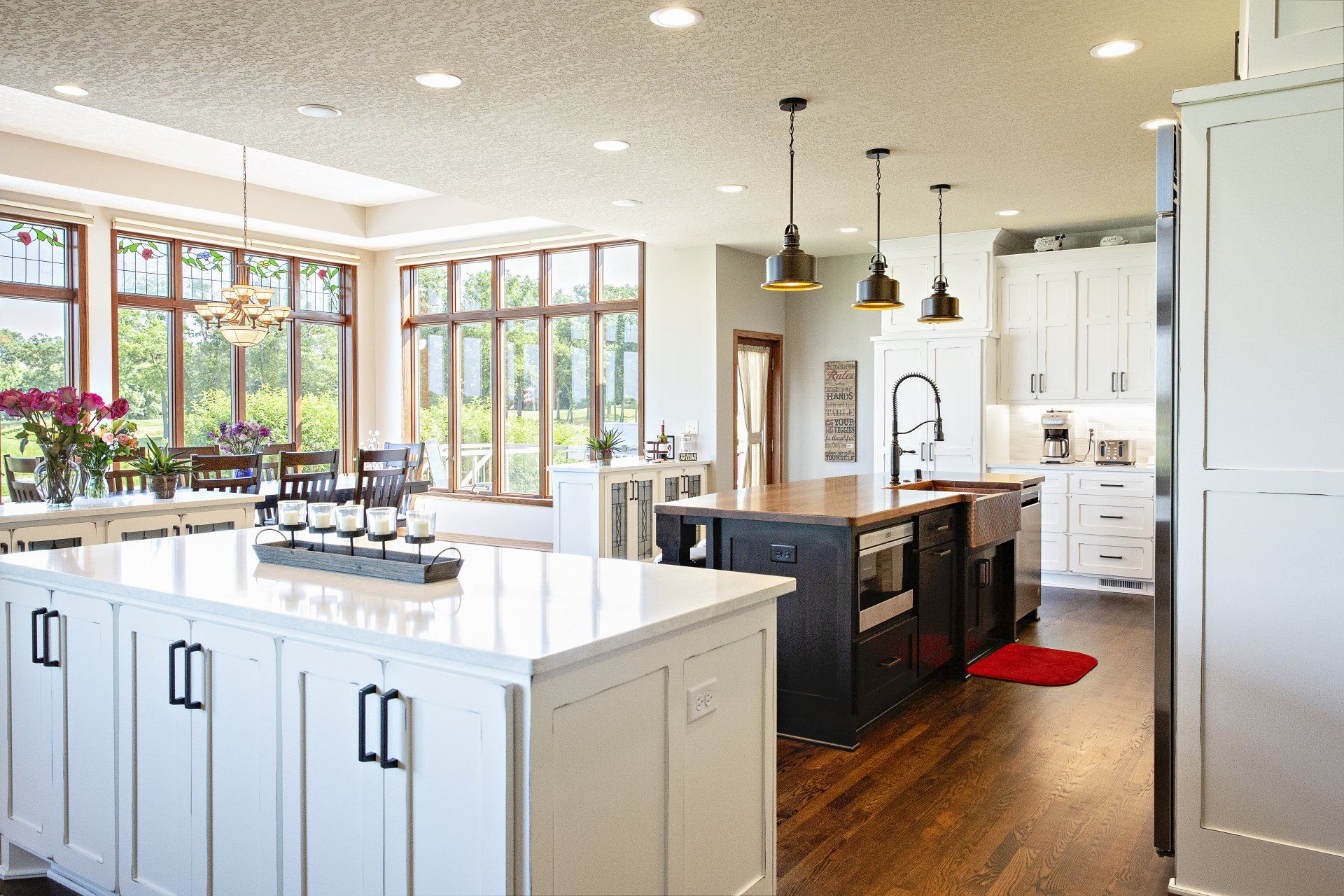 A large kitchen with white cabinets and a large island in the middle.