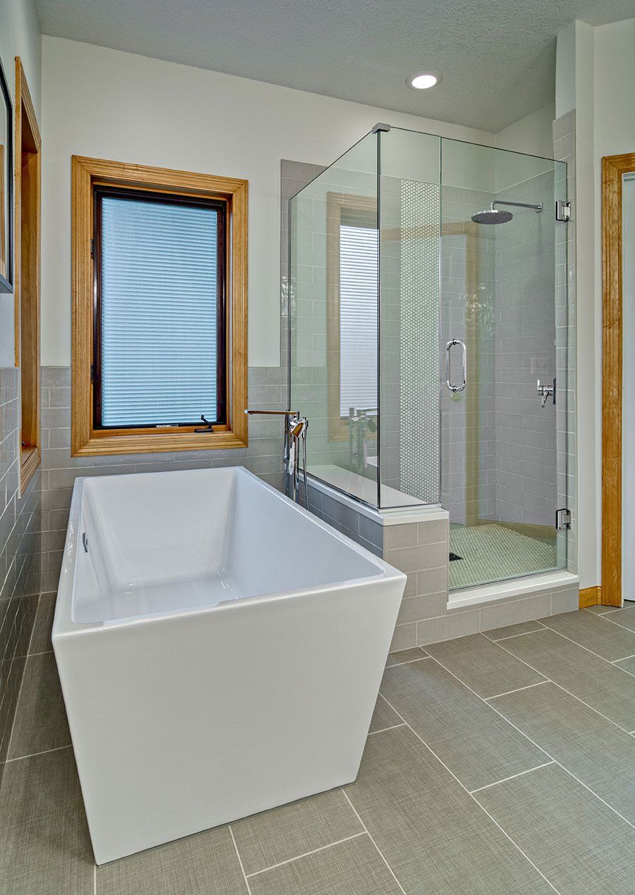 A bathroom with a bathtub and a walk in shower.