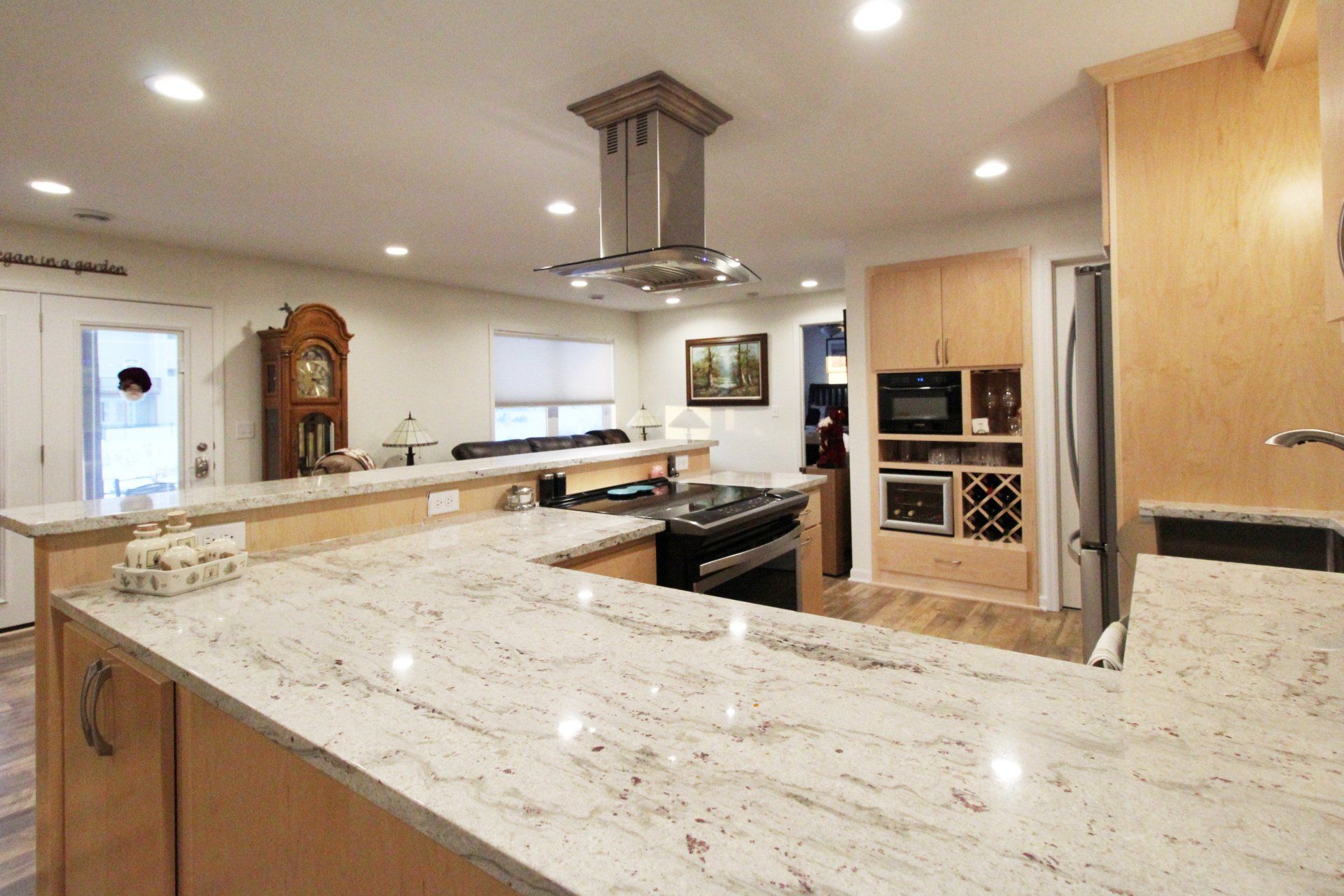 A kitchen with granite counter tops and wooden cabinets