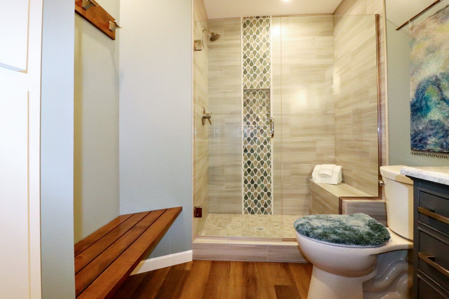 A bathroom with a toilet and a walk in shower.