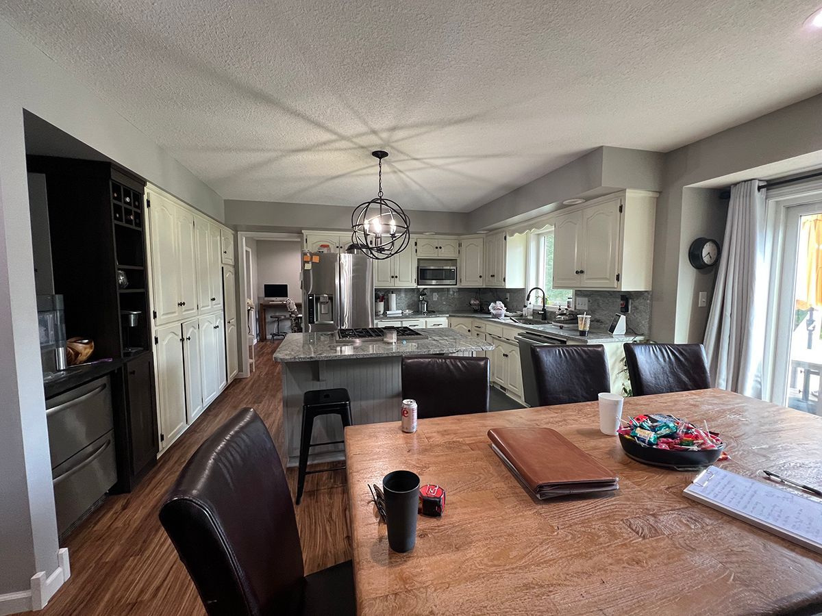 There is a dining table and chairs in the middle of the room.