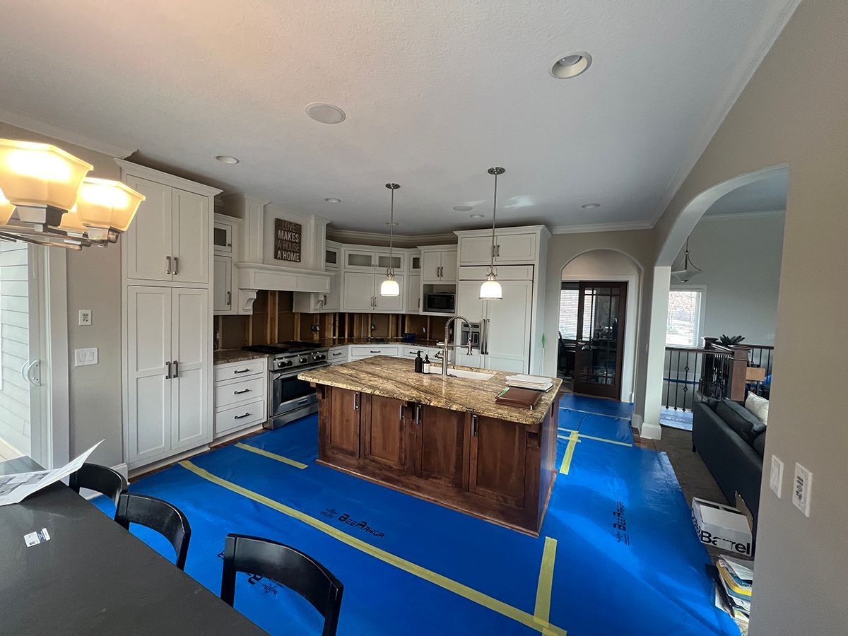 There is a dining table and chairs in the middle of the room.