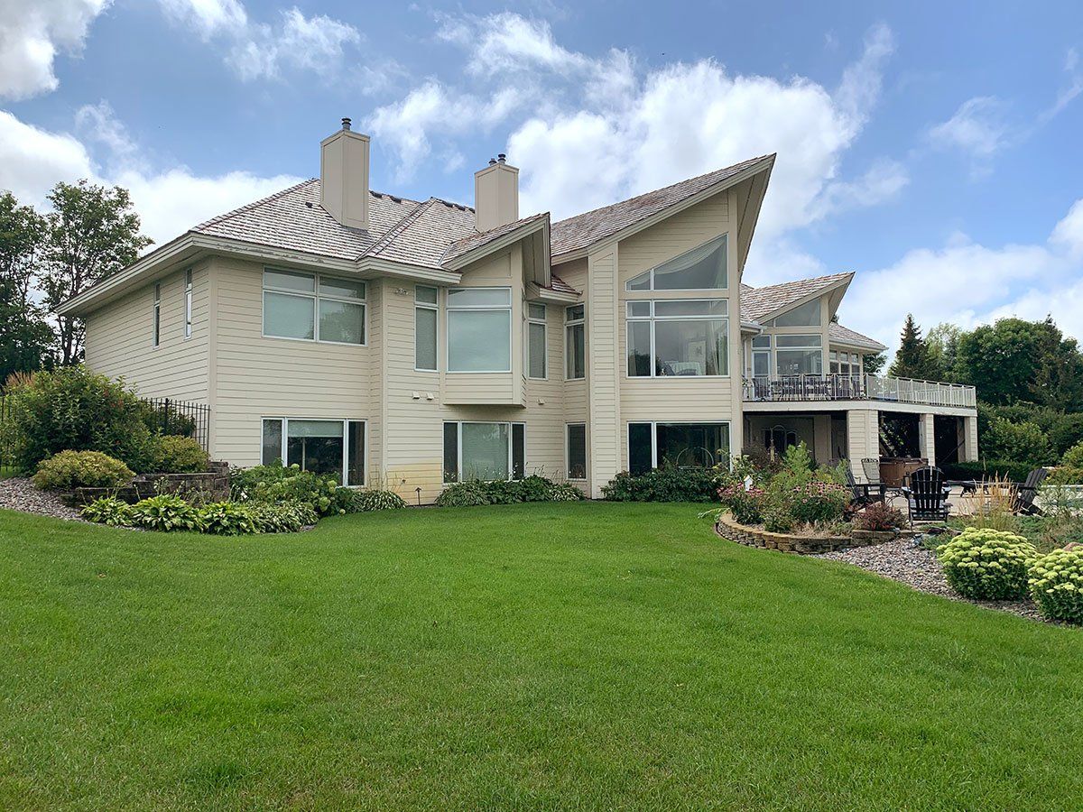 A large house with a lush green lawn in front of it