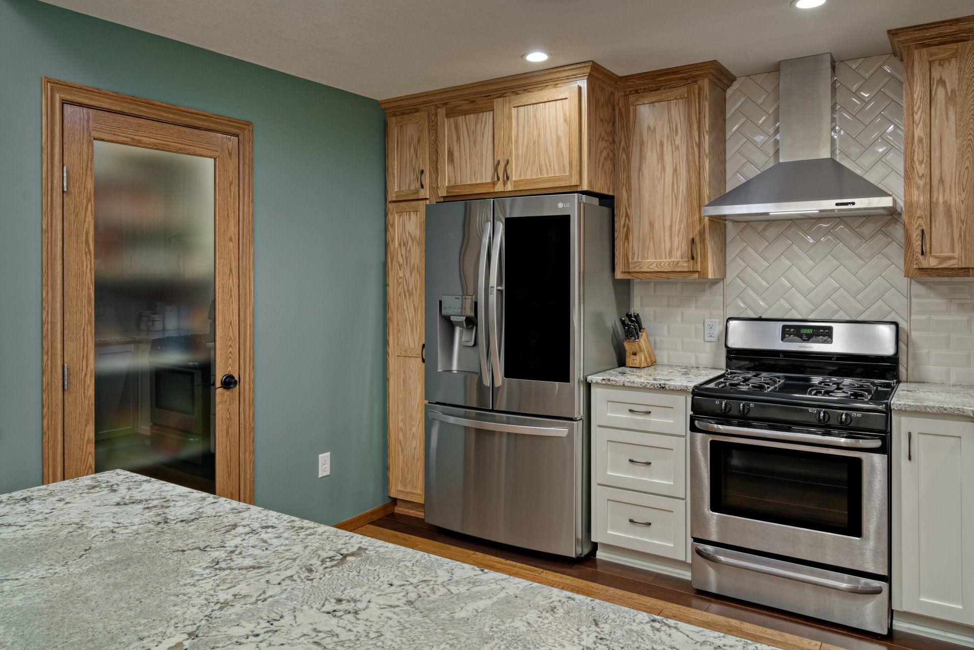 A kitchen with stainless steel appliances and wooden cabinets