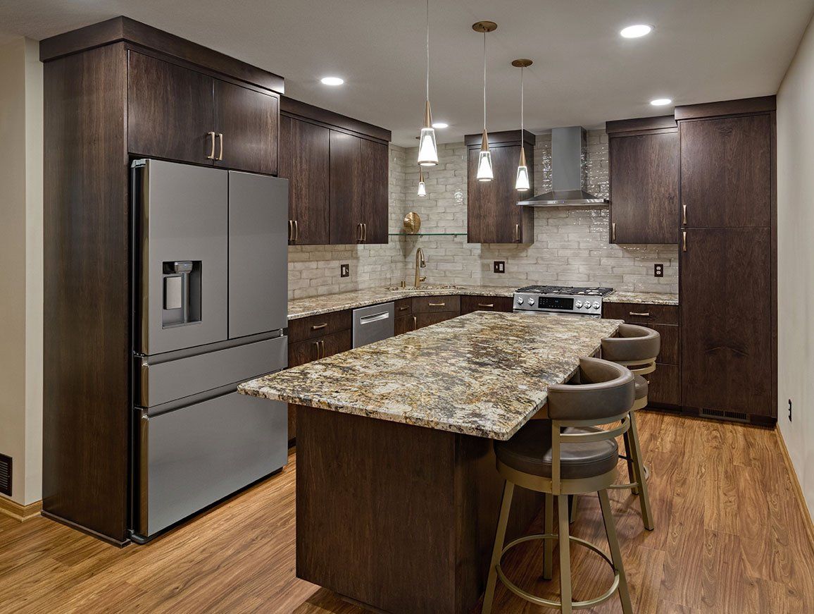 A kitchen with stainless steel appliances and granite counter tops.