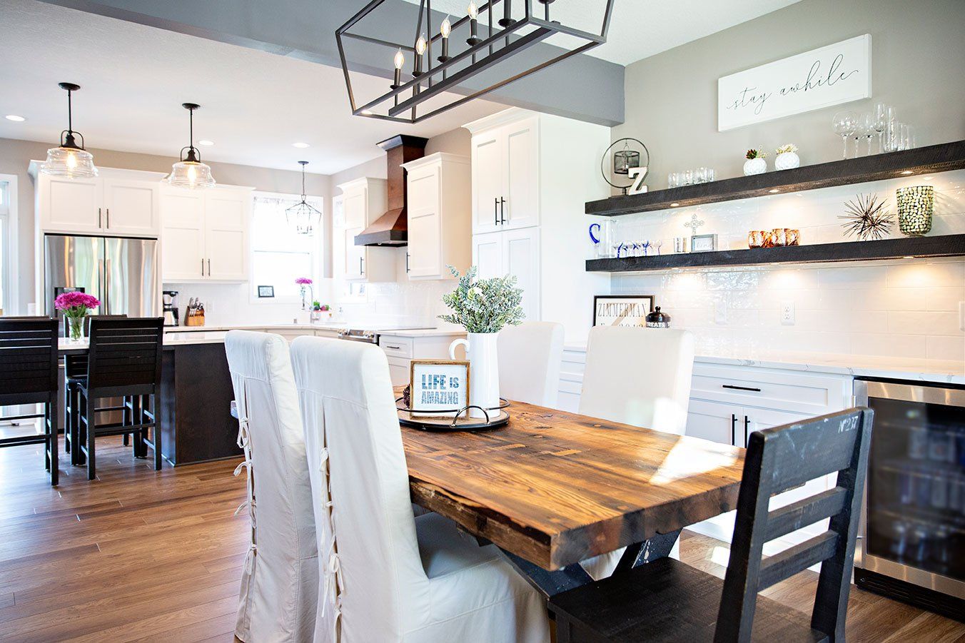 A dining room table and chairs in a kitchen.