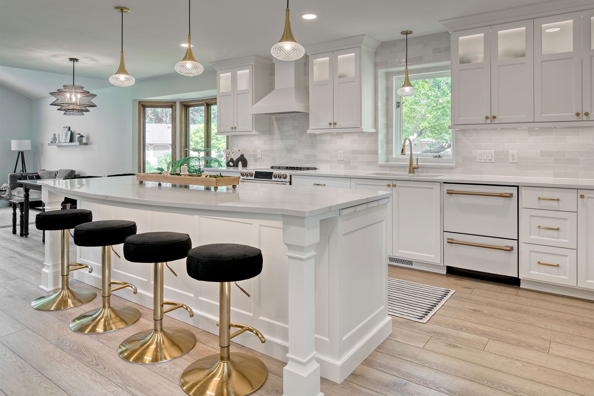 White kitchen with gold fixtures and stools