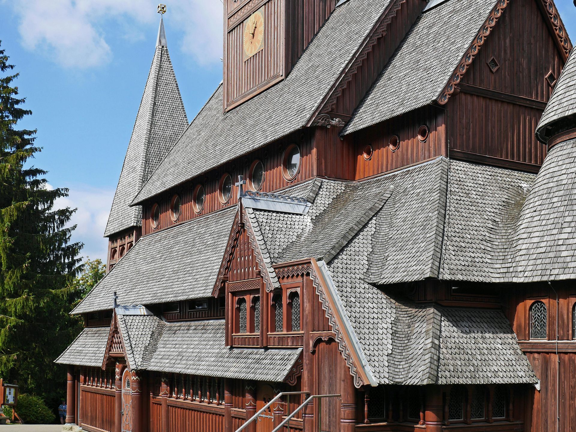 A row of houses with a gray roof and wooden windows