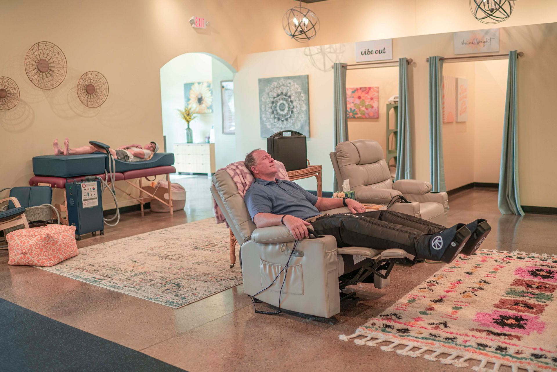 A man is sitting on the floor with a bag that says ' recovery ' on it