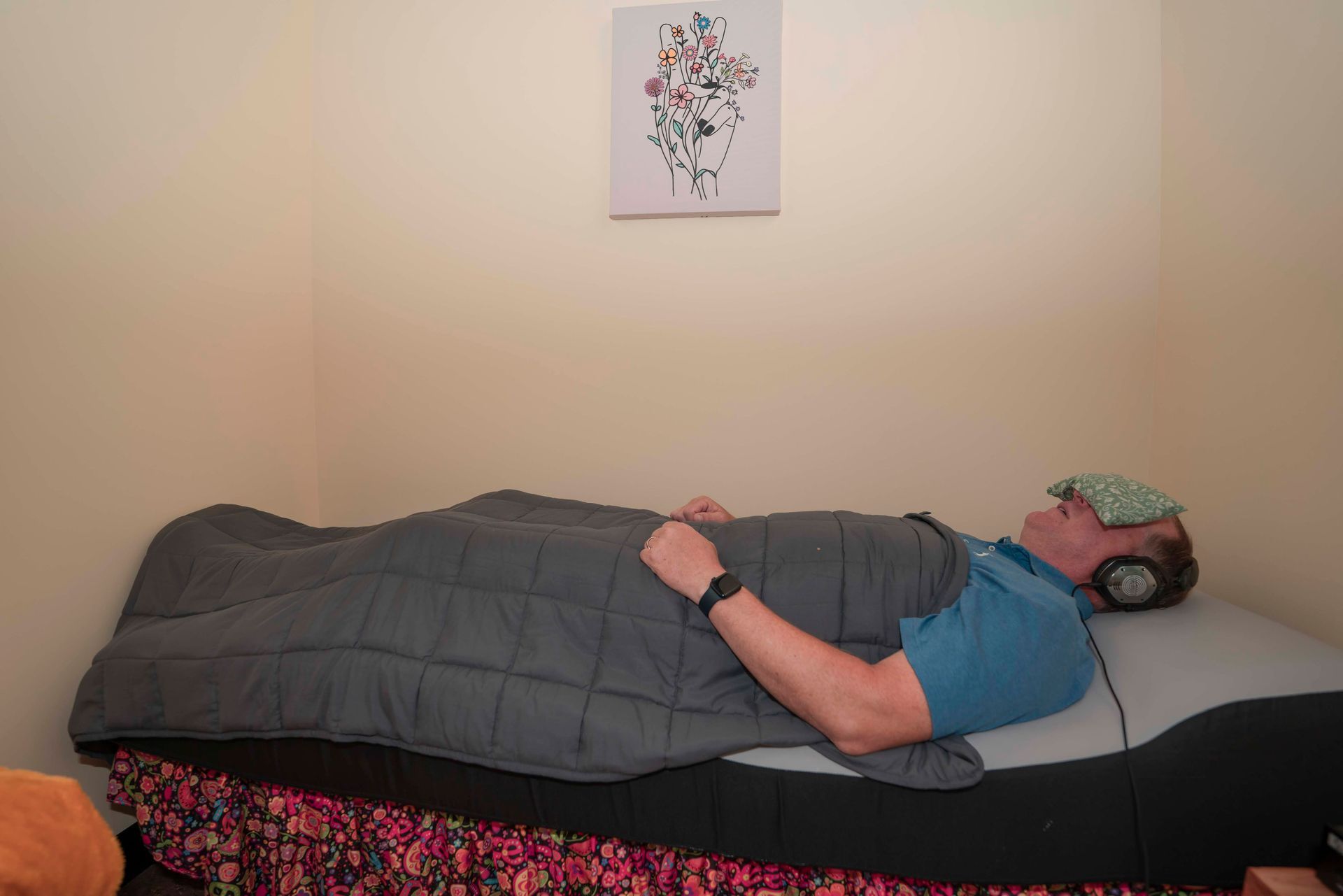 A man wearing headphones is smiling with his eyes closed