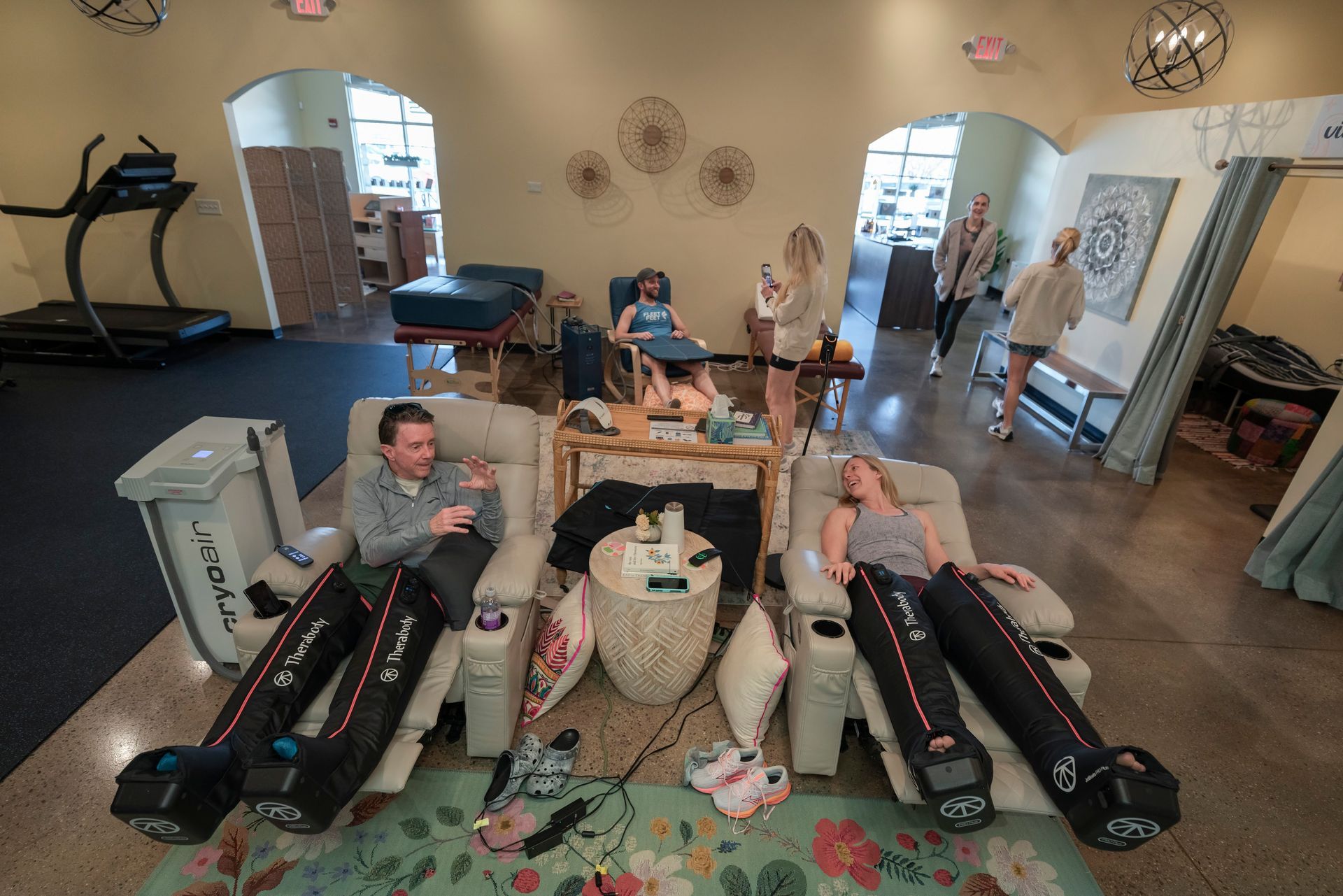 A man is sitting in a room with a machine that is filled with ice.