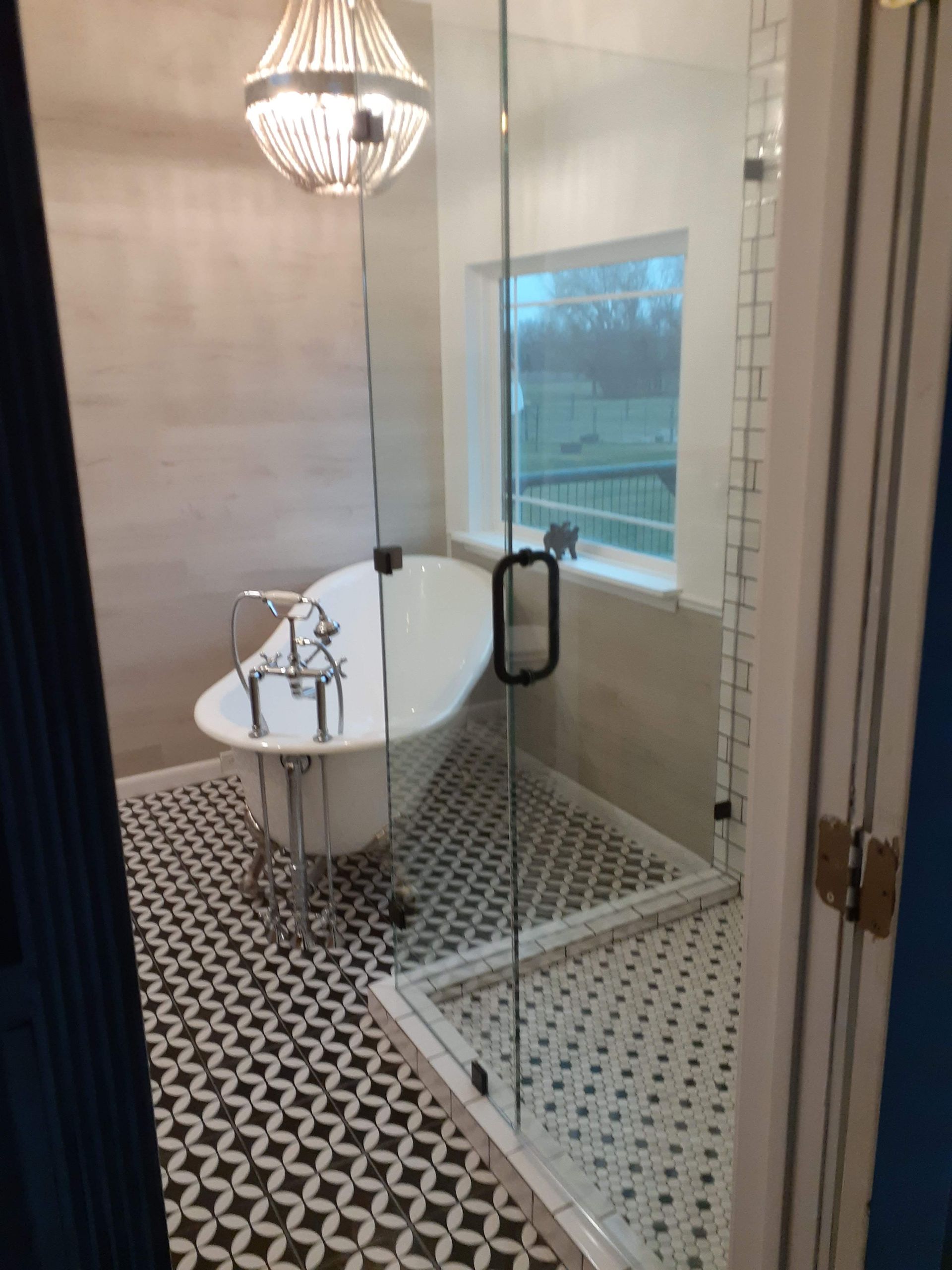 A bathroom with a claw foot tub and a walk in shower.