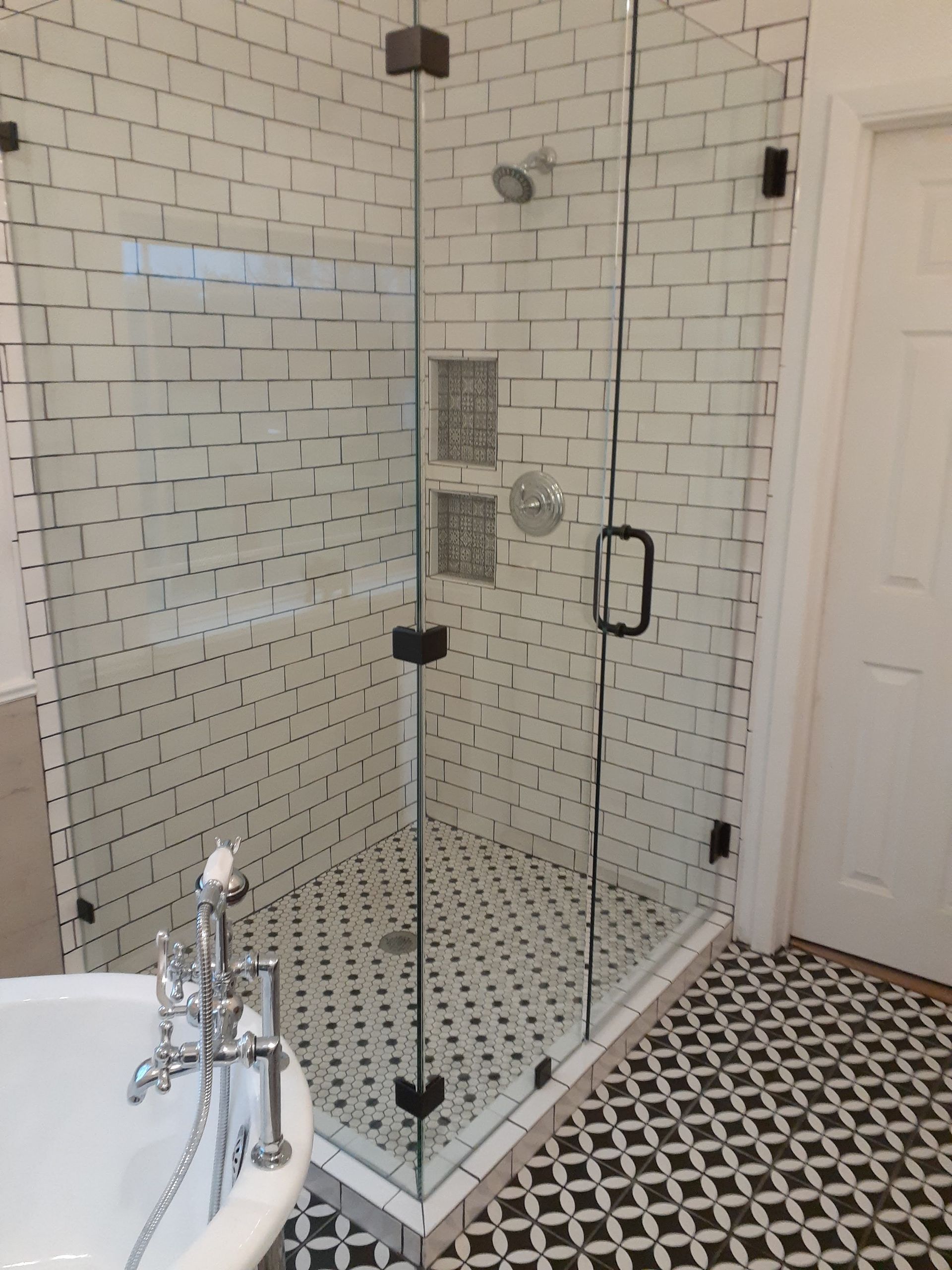 A bathroom with a walk in shower and a bathtub