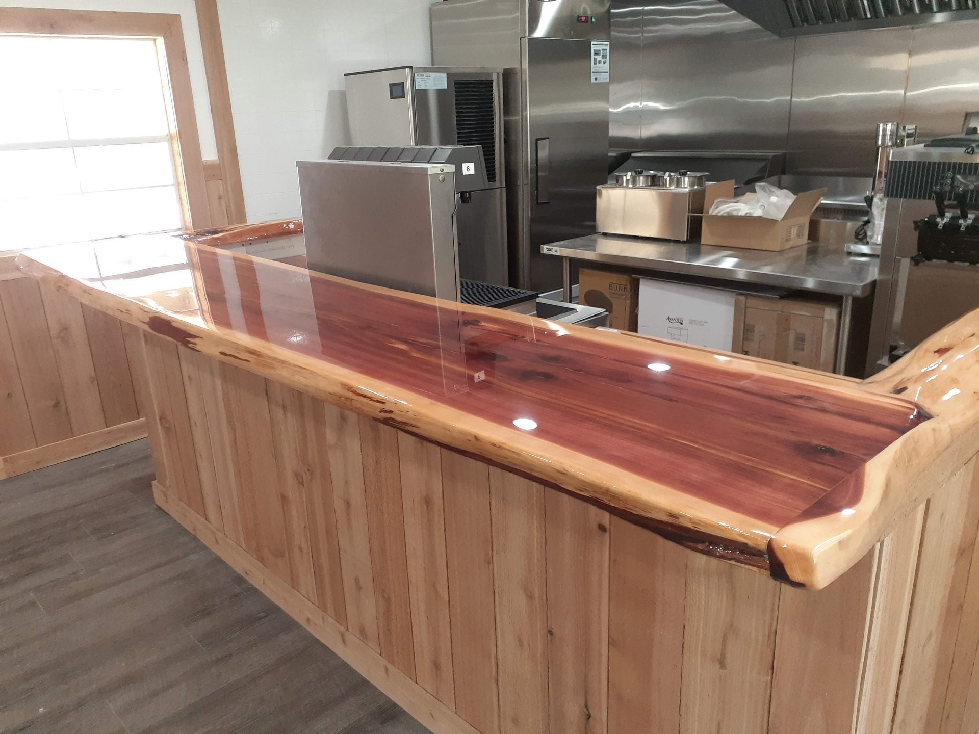 A kitchen with a wooden counter top and stainless steel appliances.