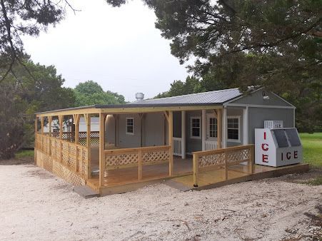 A house with a porch and an ice machine in front of it