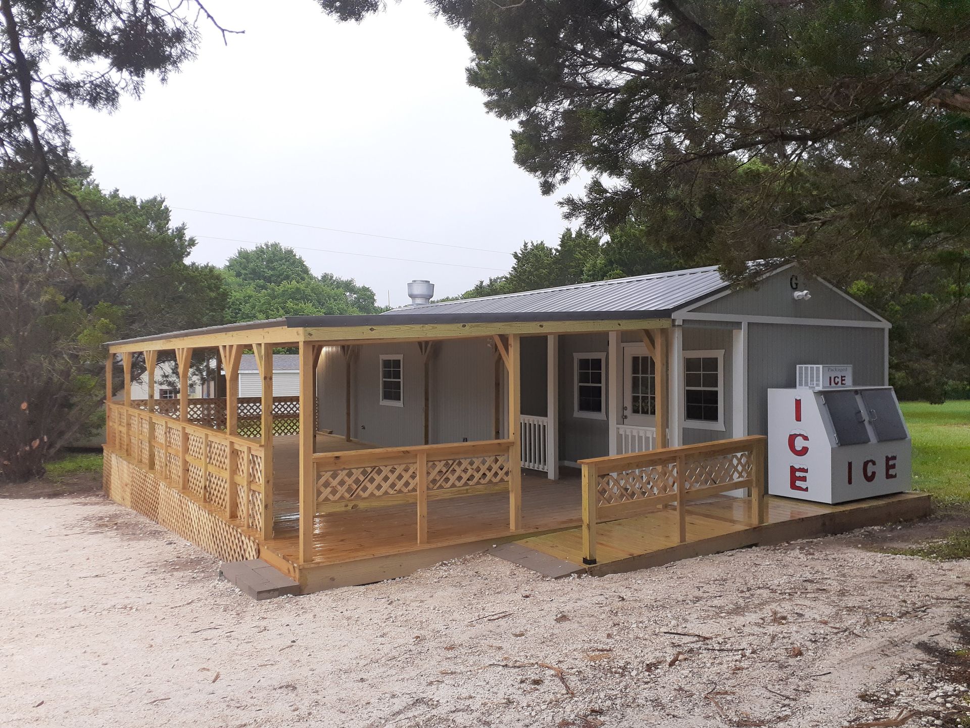 A house with a porch and an ice machine in front of it