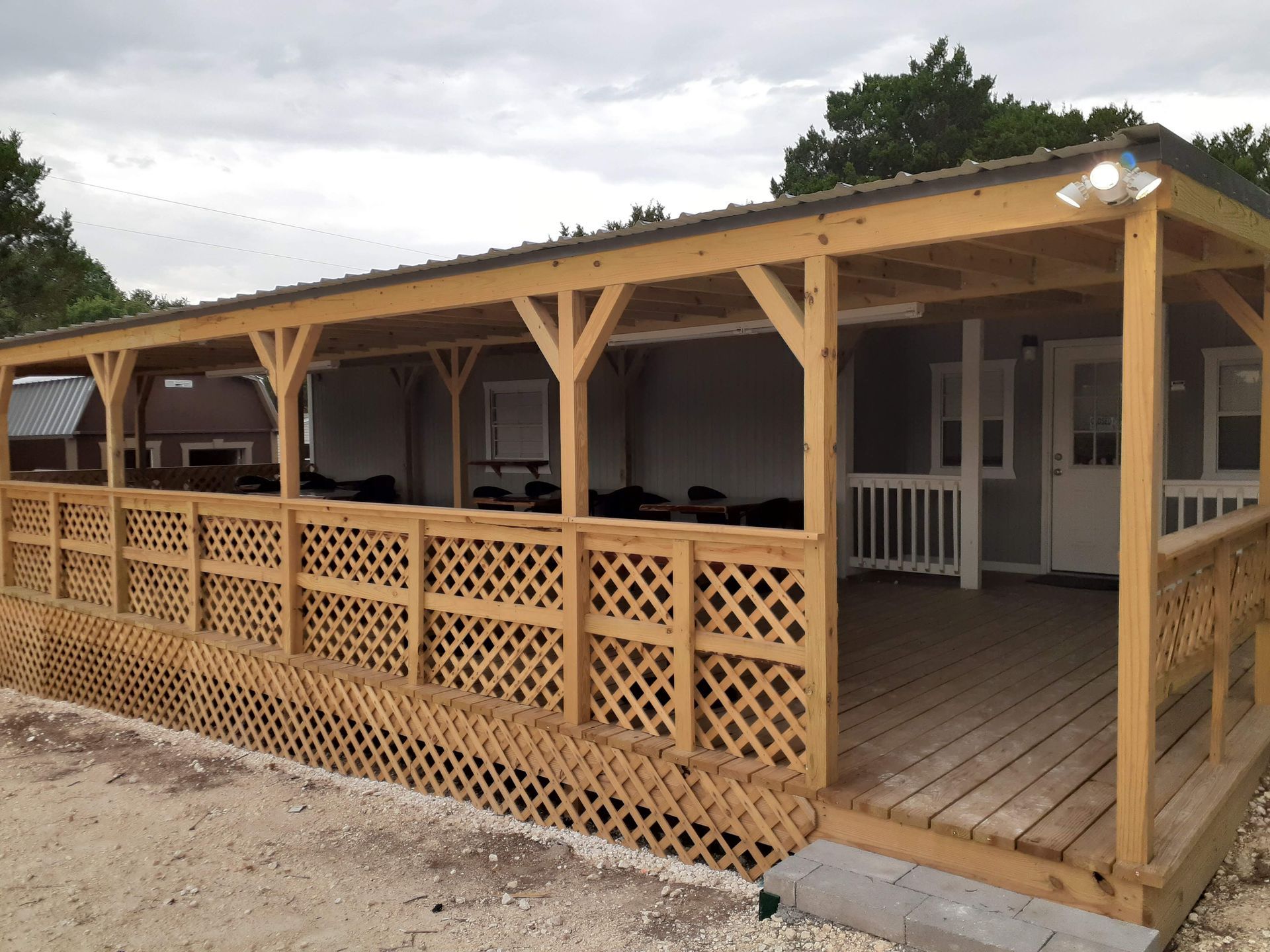A large wooden porch with a roof over it
