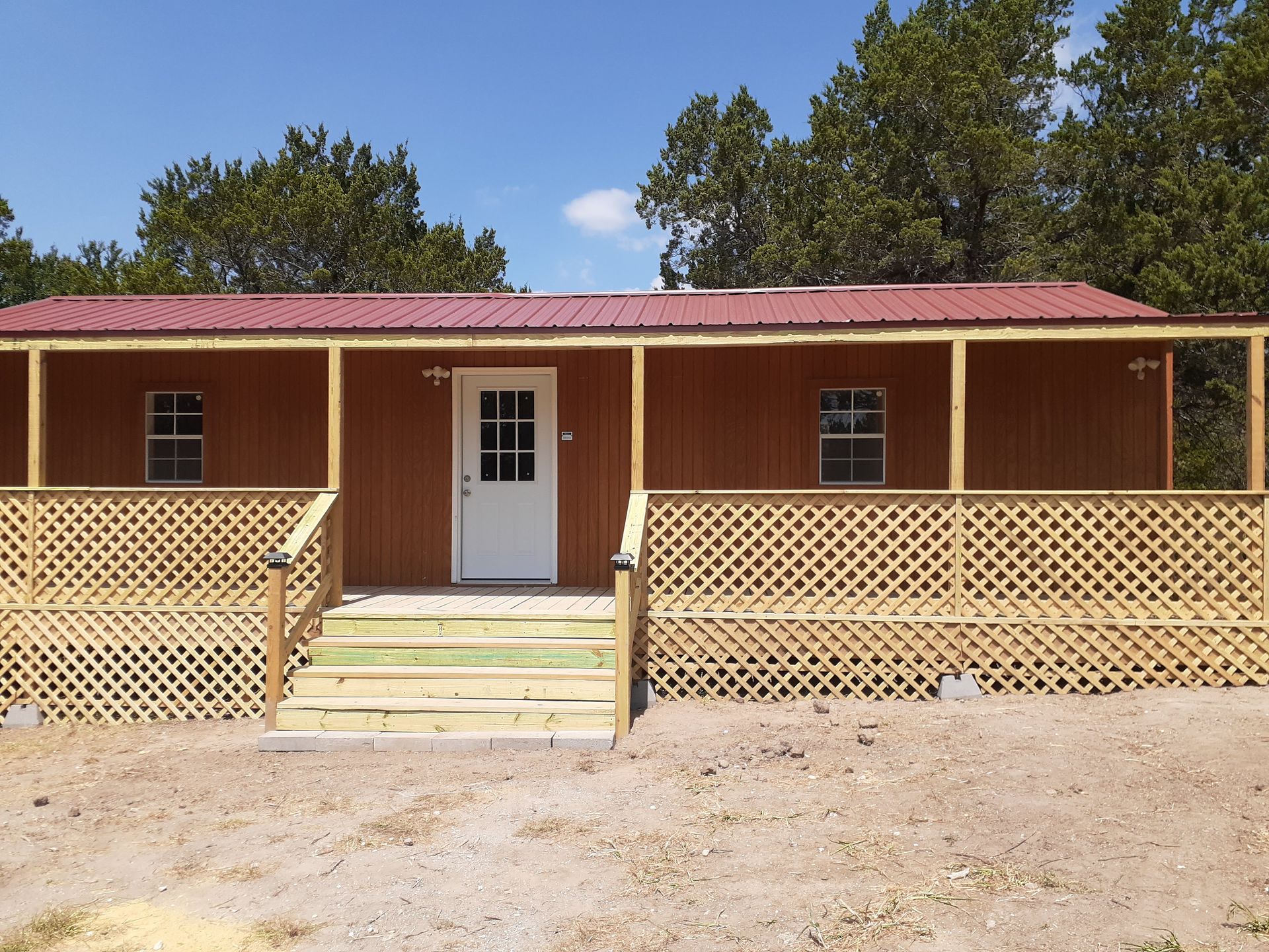 A brown house with a porch and stairs