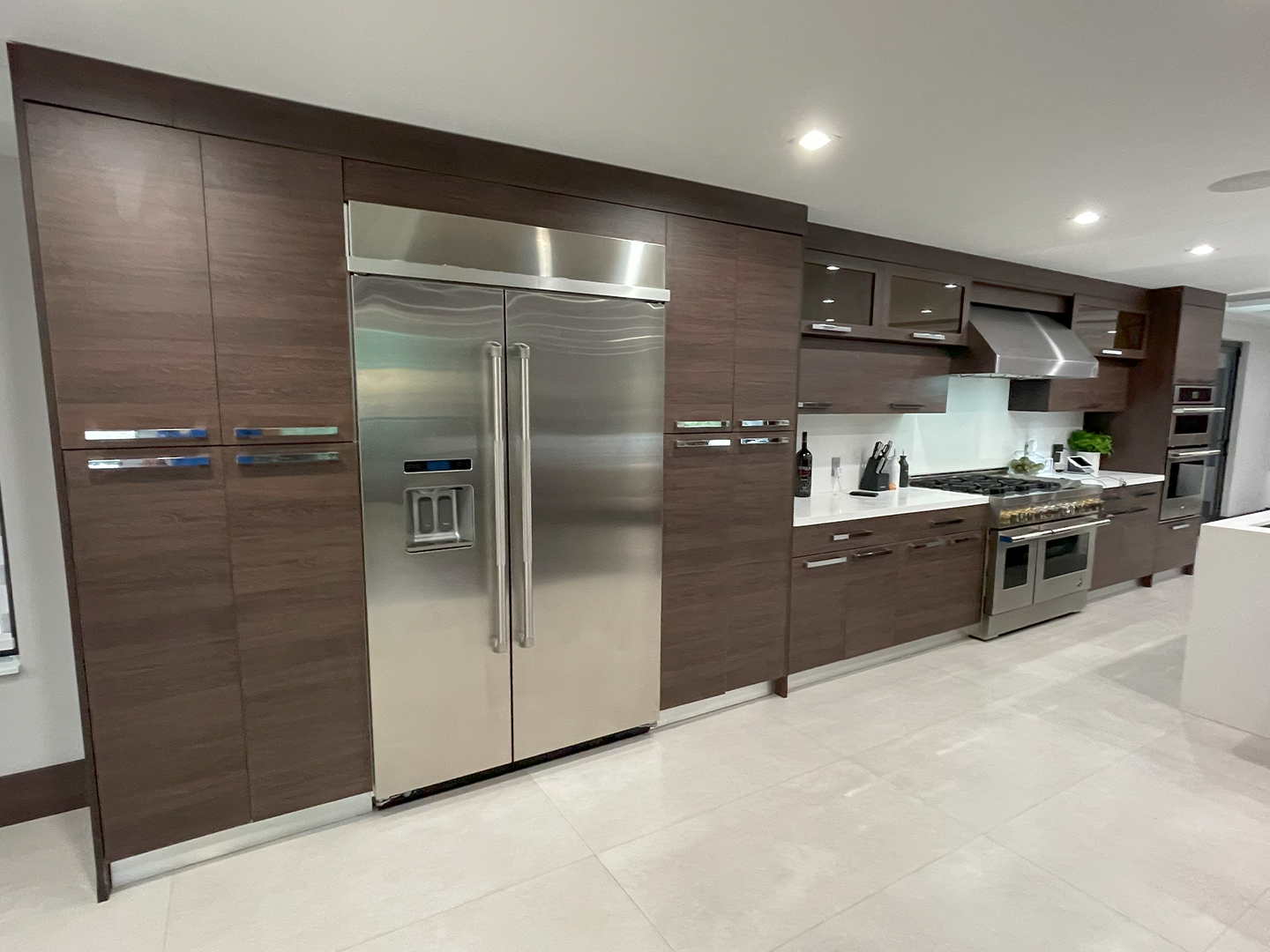 A kitchen with stainless steel appliances and wooden cabinets.