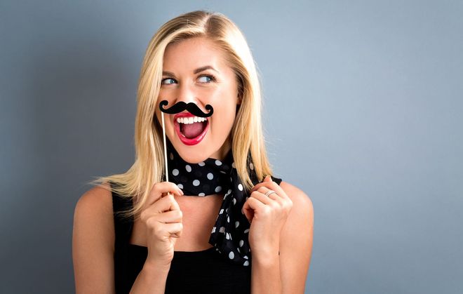 girl in photo booth with prop