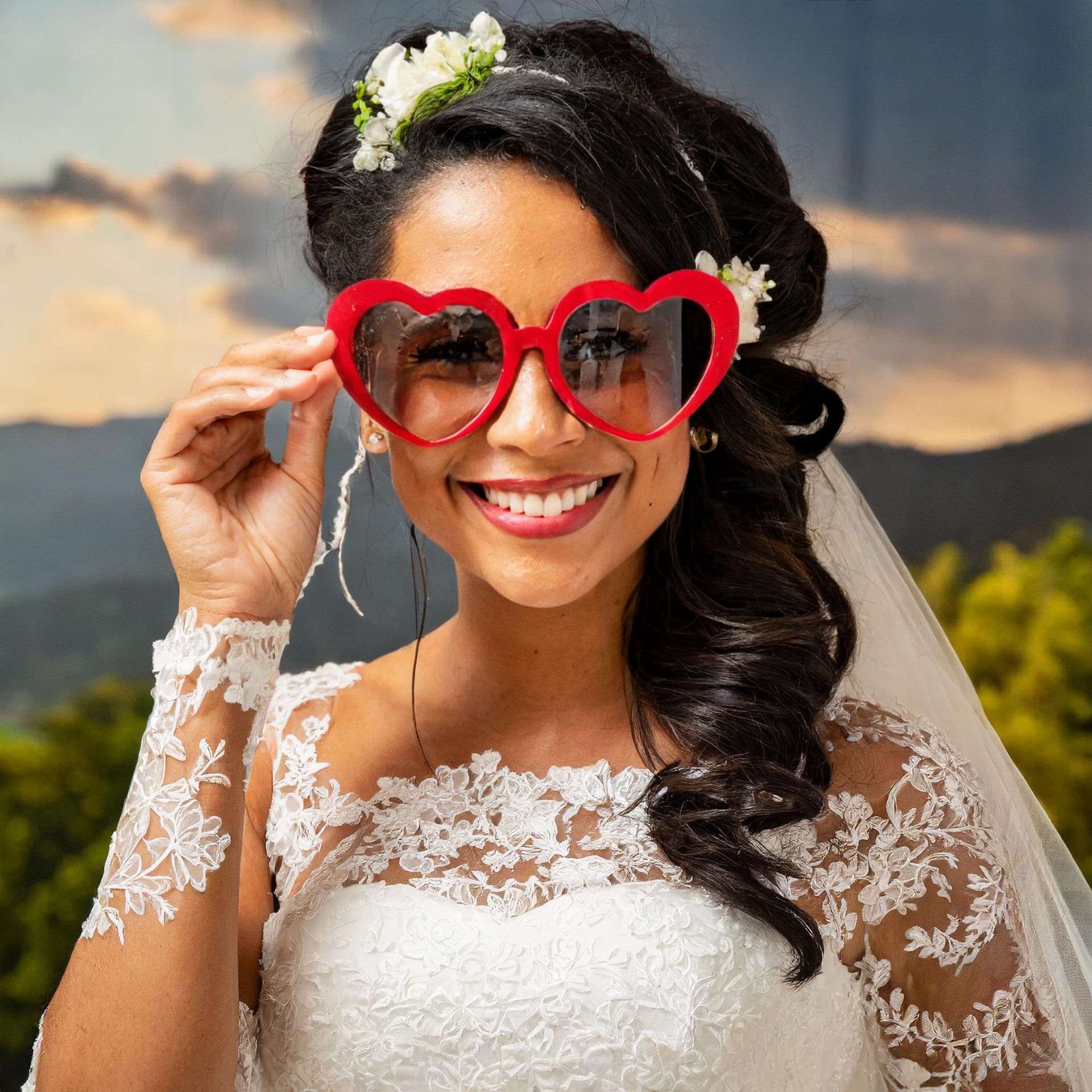 a bride wearing a veil and heart shaped sunglasses