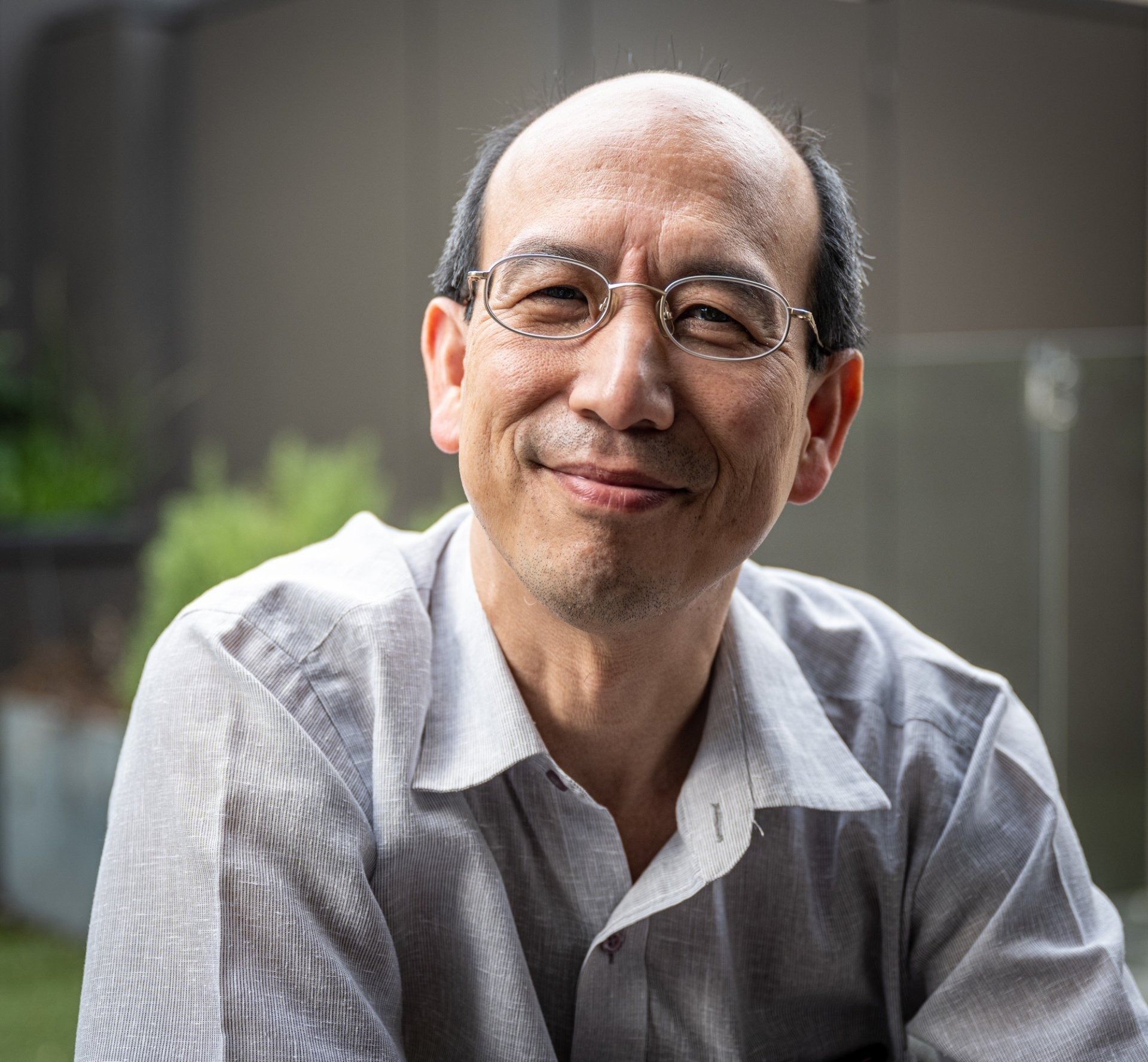 Man With Glasses Smiles, Wearing a Light-colored Button-down Shirt — Tamworth Orthocare In Tamworth, NSW